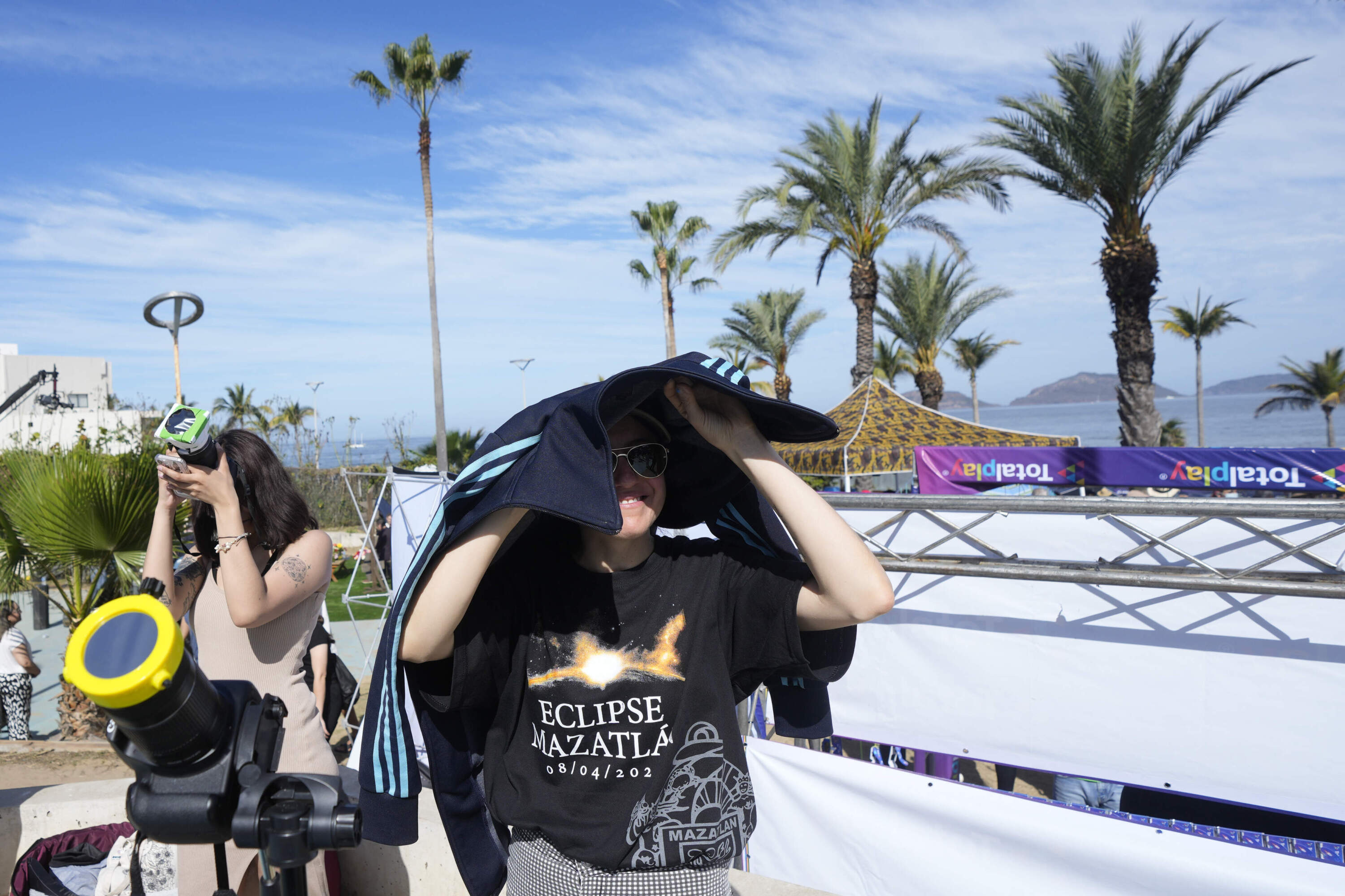People prepare to photograph a total solar eclipse in Mazatlan, Mexico, Monday, April 8, 2024. (Fernando Llano/AP)
