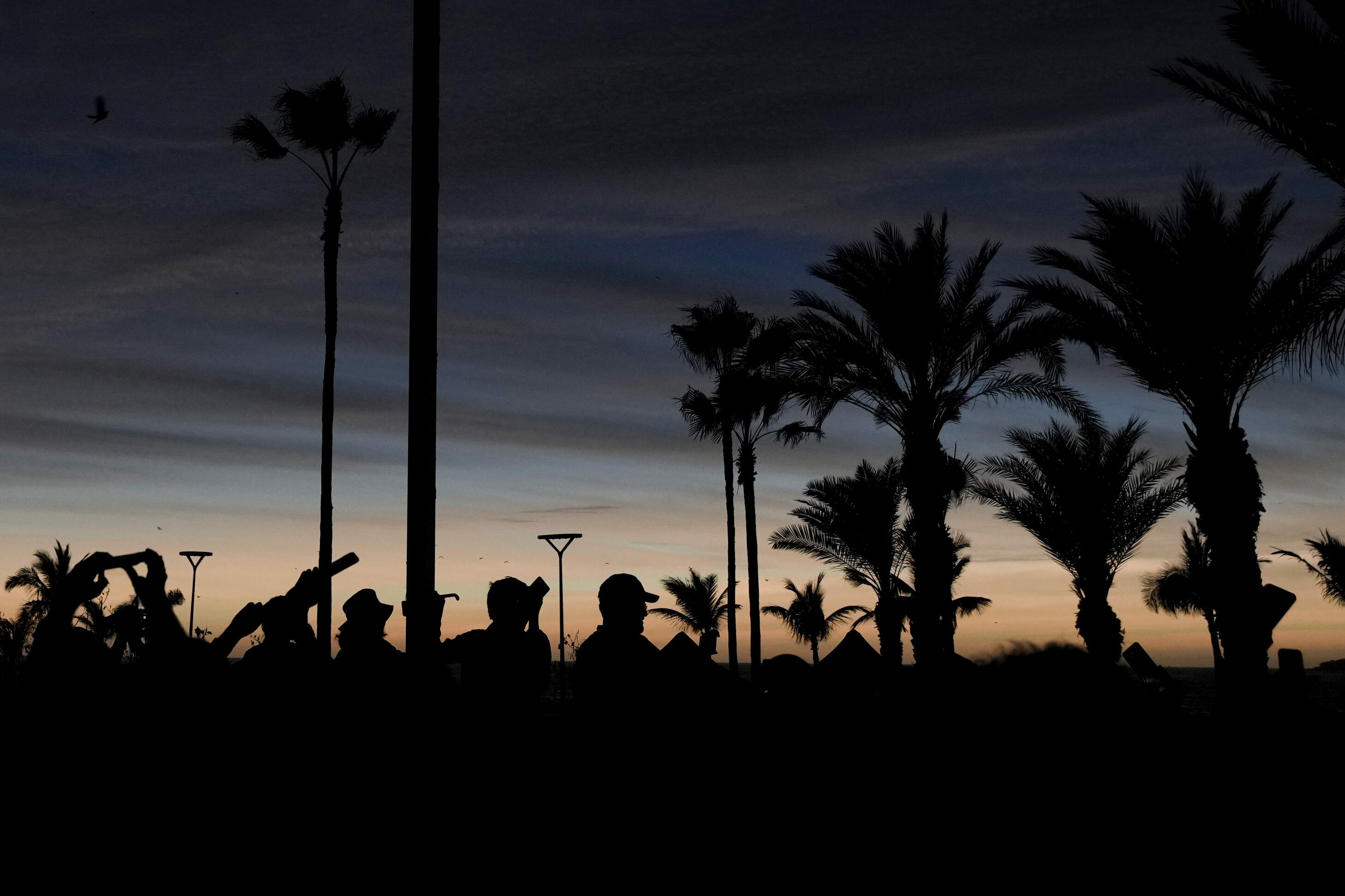 People watch a total solar eclipse as the sky goes dark in Mazatlan, Mexico, Monday, April 8, 2024. (Fernando Llano/AP)