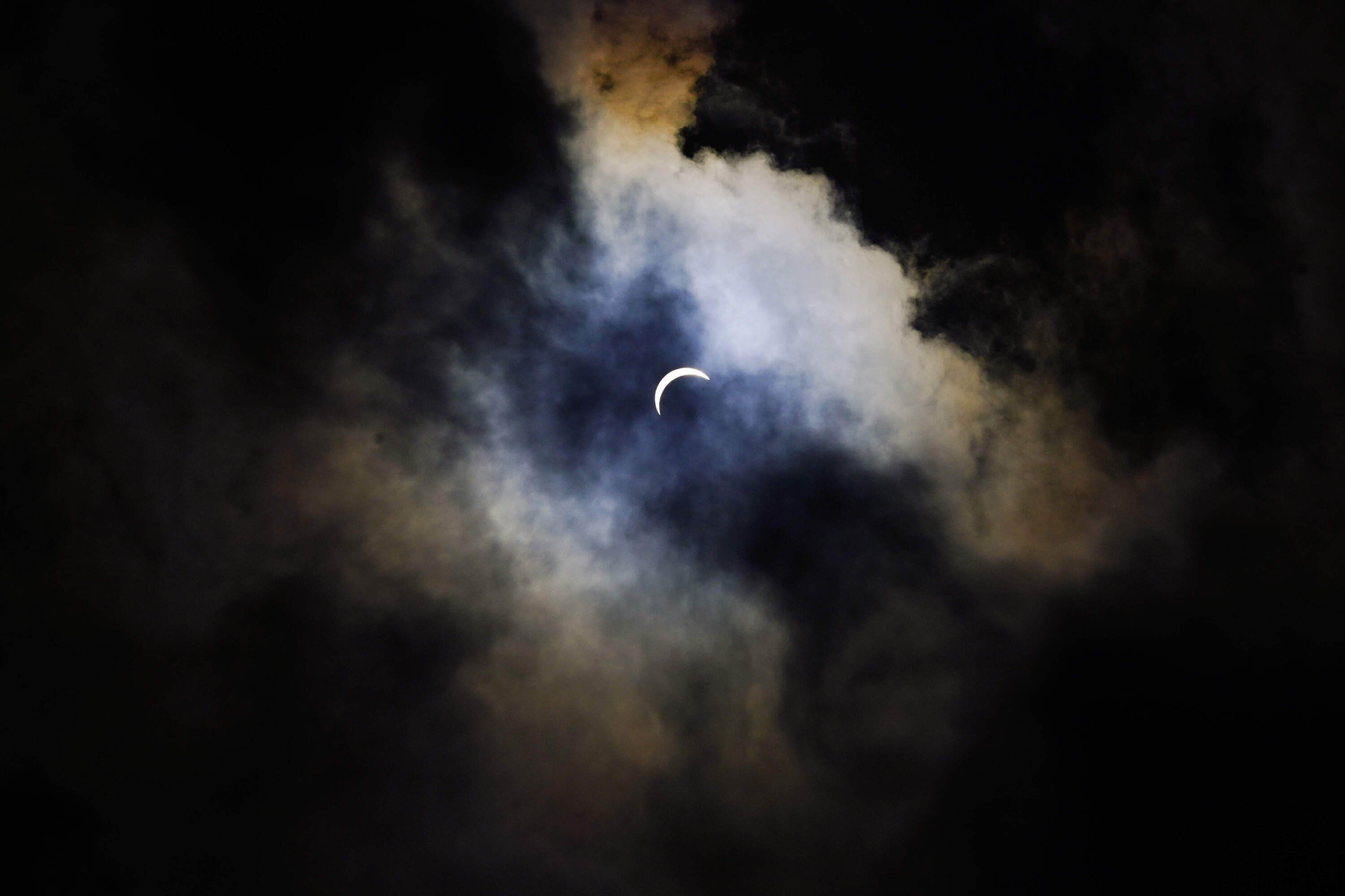 Clouds cover the sky prior to a total solar eclipse in Arlington, Texas. (Julio Cortez/AP)