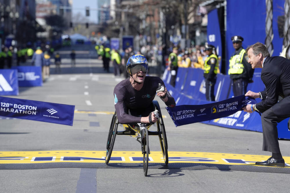 Marcel Hug, of Switzerland, breaks the tape to win the men's wheelchair division of the Boston Marathon on April 15, 2024. (Steven Senne/AP)