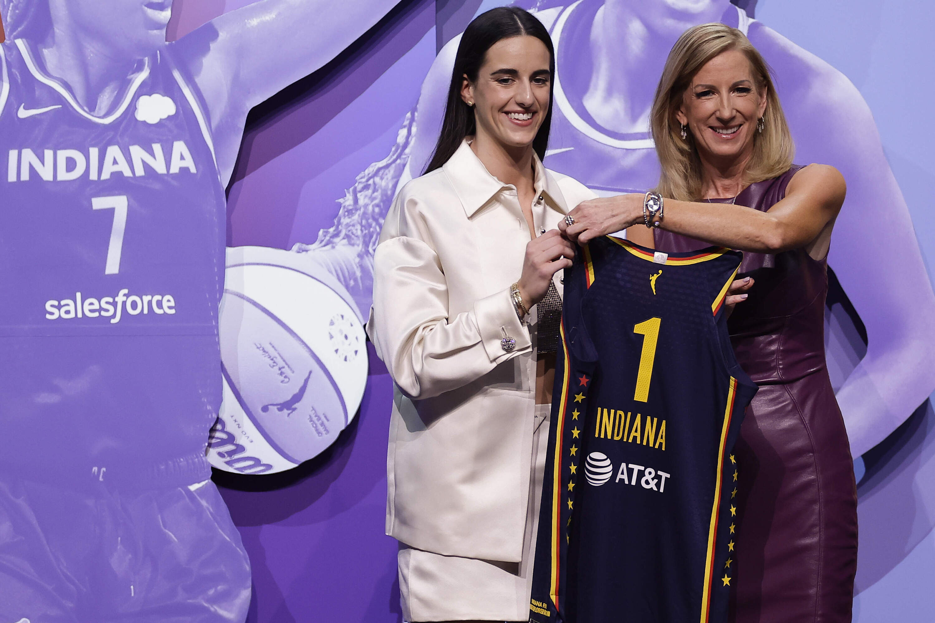 owa's Caitlin Clark, left, poses for a photo with WNBA commissioner Cathy Engelbert, right, after being selected first overall by the Indiana Fever during the first round of the WNBA basketball draft, Monday, April 15, 2024, in New York. (Adam Hunger/AP)