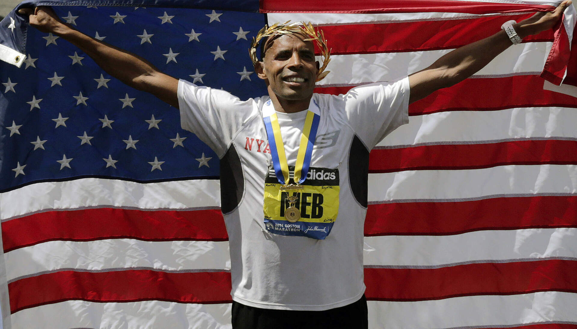 Meb Keflezighi celebrates his victory with an American flag after the 118th Boston Marathon April 21, 2014 in Boston. (Charles Krupa/AP)