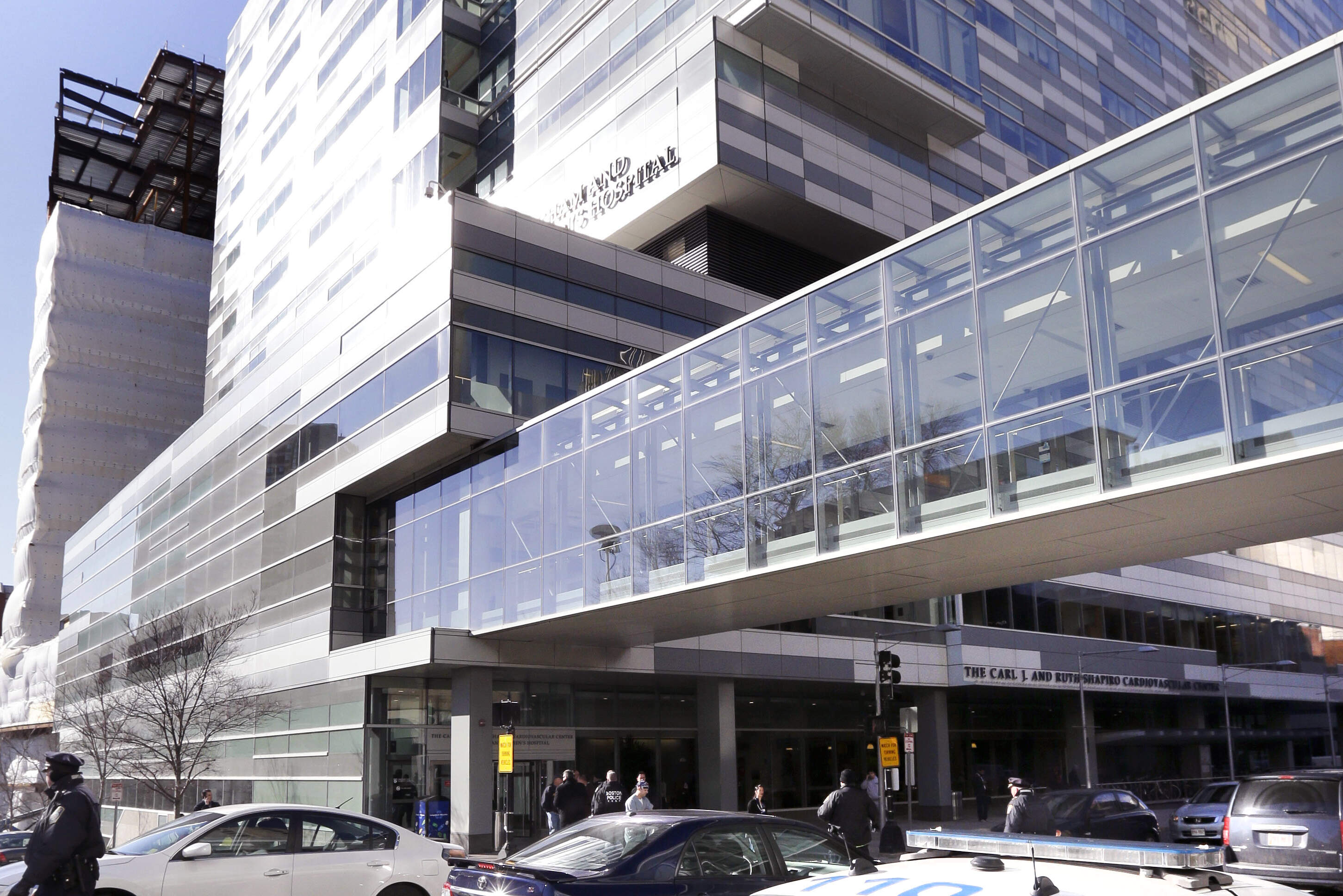 Pedestrians walk past the Shapiro Building at Brigham and Women's Hospital in Boston. (Steven Senne/AP)