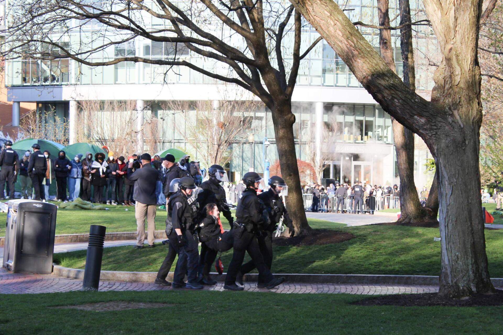 Police arrest and carry away a person from an encampment on the Northeastern University campus. (Kevin Gallagher/Huntington News)