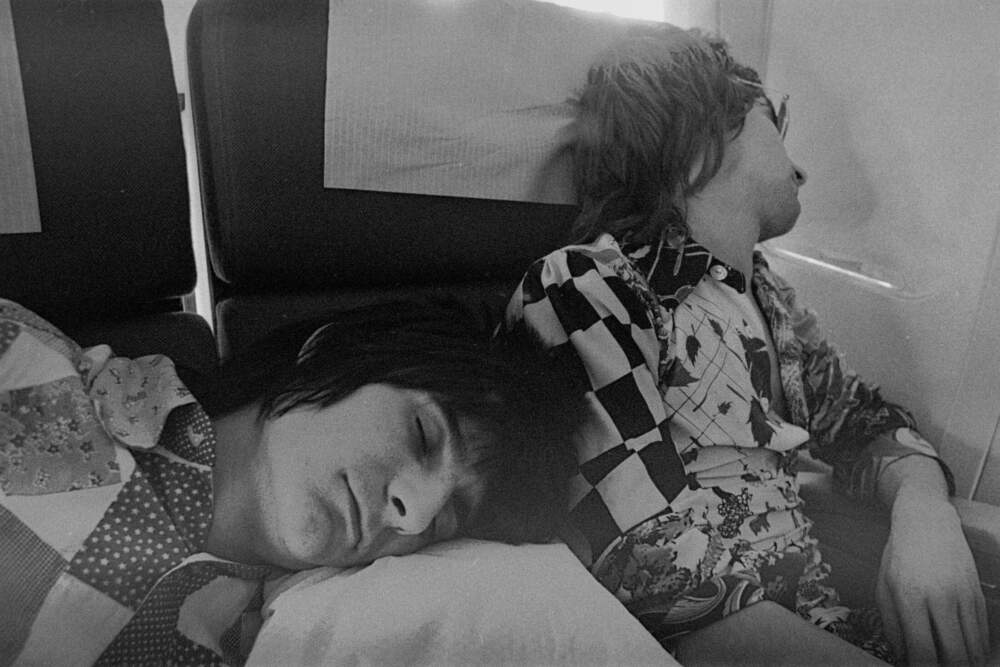 Ron Wood and Rod Stewart, asleep on a plane while touring with their band Faces (Courtesy Susan Berstler)