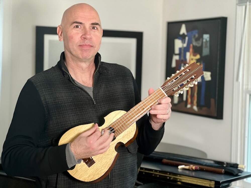 Eric Shimelonis plays the cuatro: a small, five-stringed musical instrument that’s become a staple of Puerto Rican culture. (Courtesy of Rebecca Sheir)