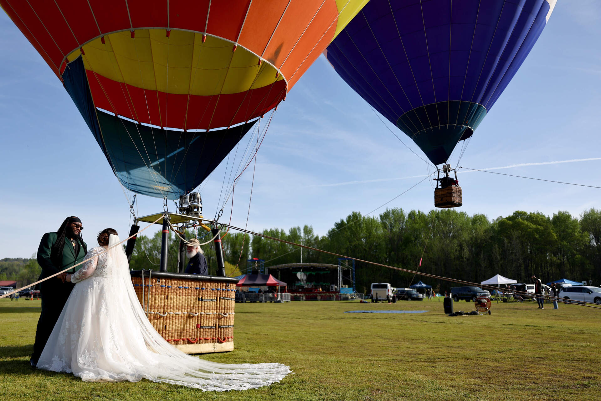 Bride and groom Kylee and Michael Rice prepare to take a hot air balloon ride before a planned mass wedding of over 200 couples at the Total Eclipse of the Heart festival on April 8, 2024 in Russellville, Arkansas. (Mario Tama/Getty Images)