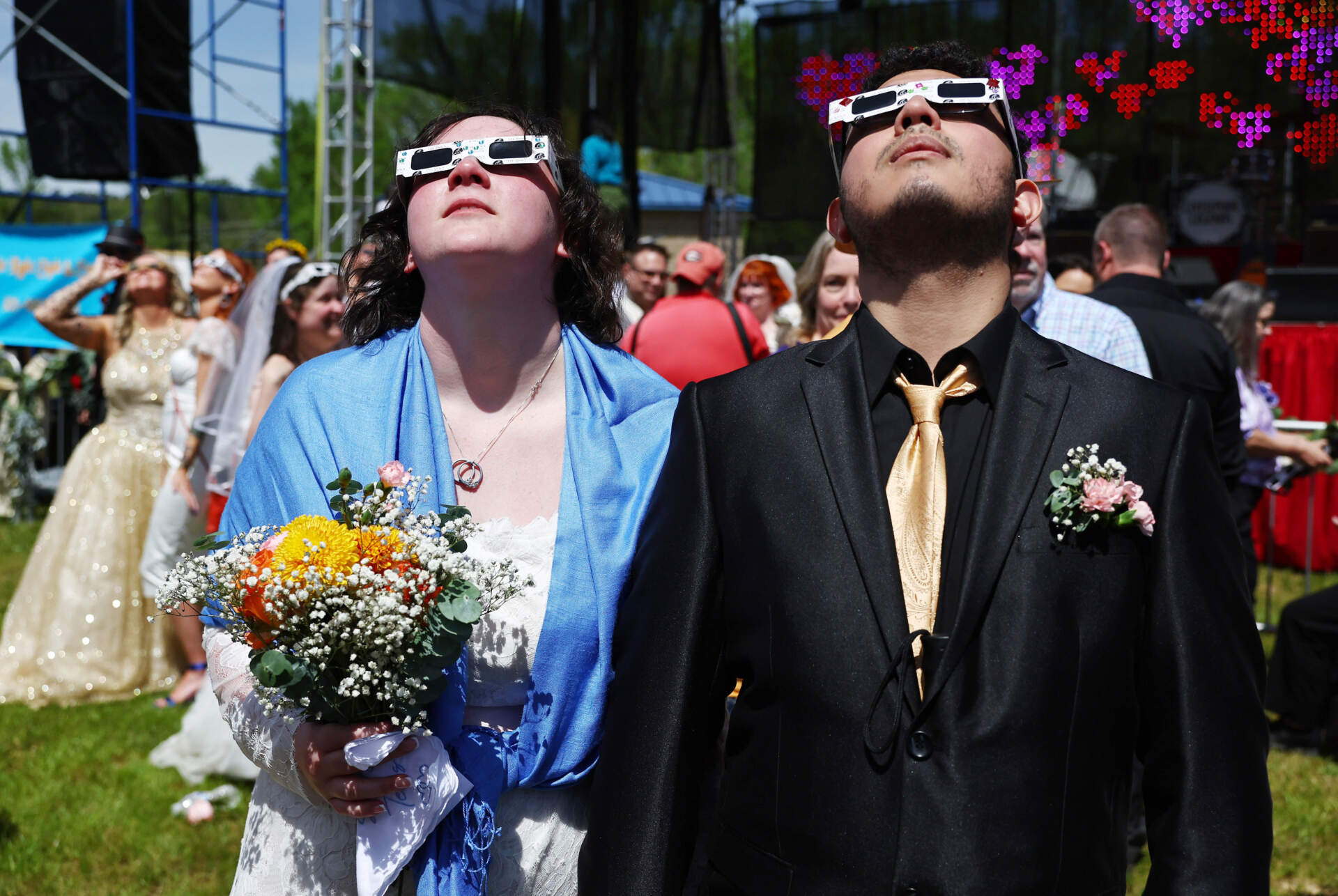 Couples view the solar eclipse during a mass wedding at the Total Eclipse of the Heart festival in Russellville, Arkansas. (Mario Tama/Getty Images)