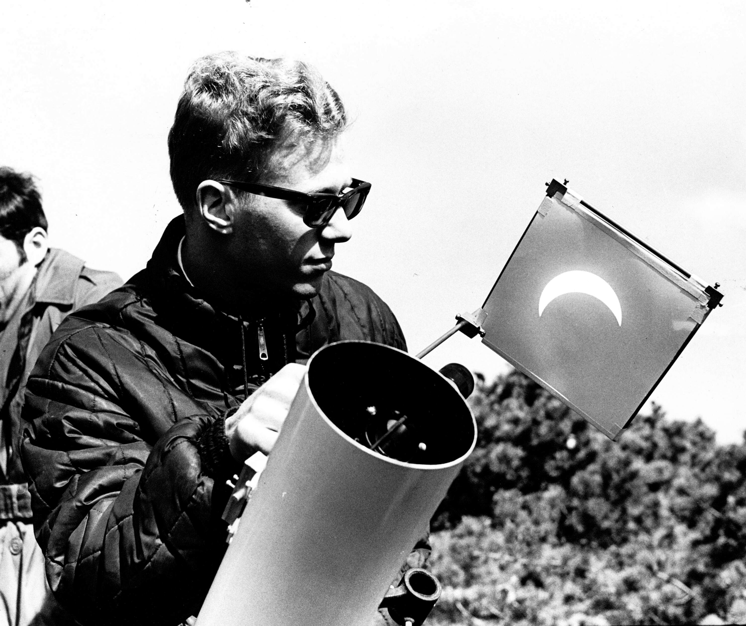 Ronald Cody, a second year graduate student in physics at Rutgers, uses a telescope to view the total solar eclipse in Nantucket, on March 7, 1970. (Bill Ryerson/The Boston Globe via Getty Images)