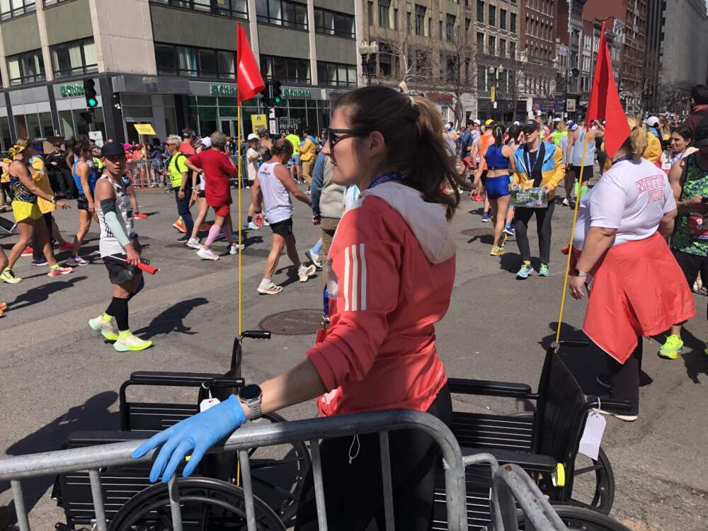 Medical volunteers in red coats near the end of the marathon in Boston. (Martha Bebinger/WBUR)