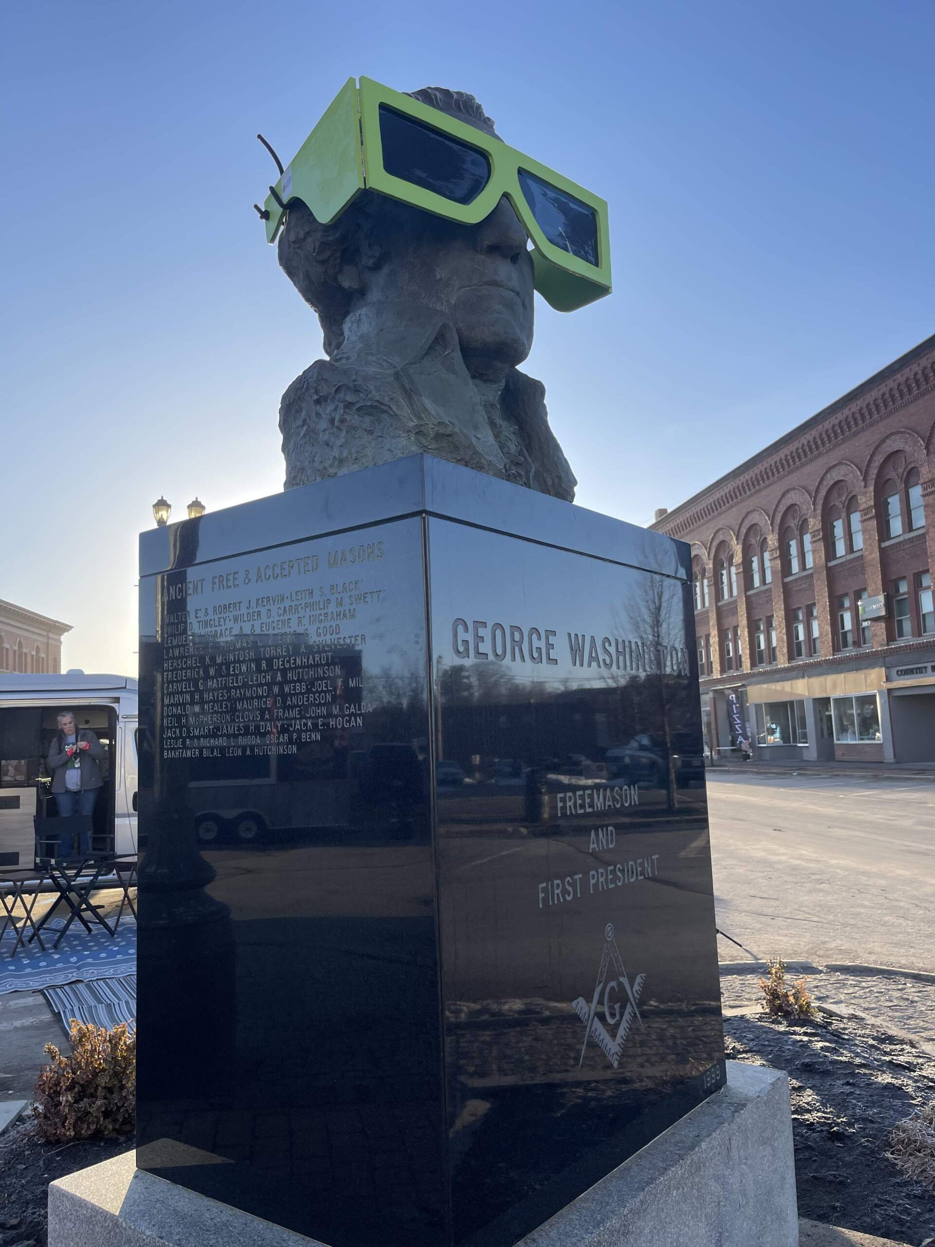 A bust of George Washington gets its own set of protective glasses ahead of the solar eclipse in Houlton, Maine. (Brian Bechard/Maine Public)