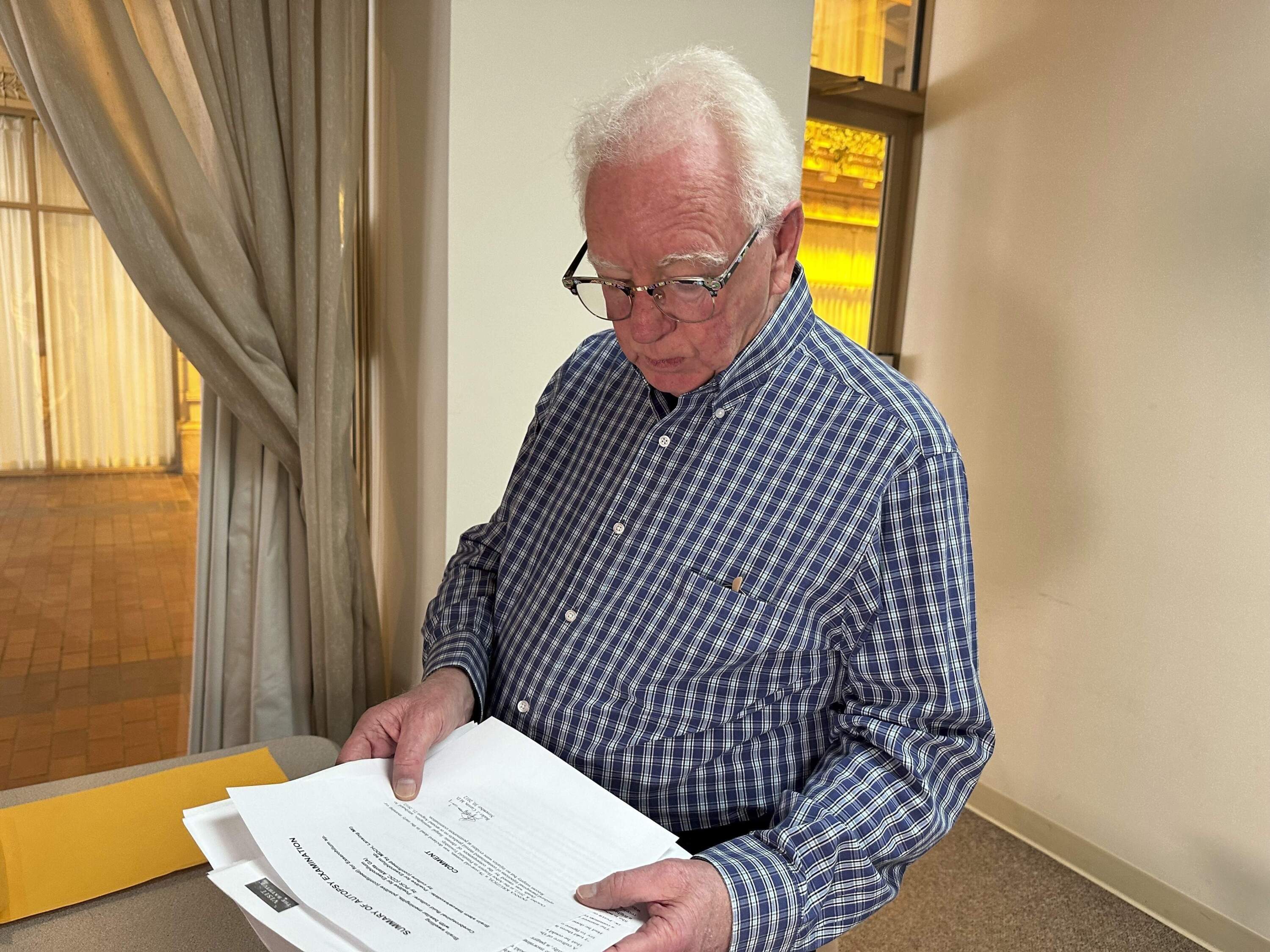 Michael Kruzich looks over his late mother's autopsy results Monday, April 15, 2024, in Lansing, Mich. (Mike Householder/AP)