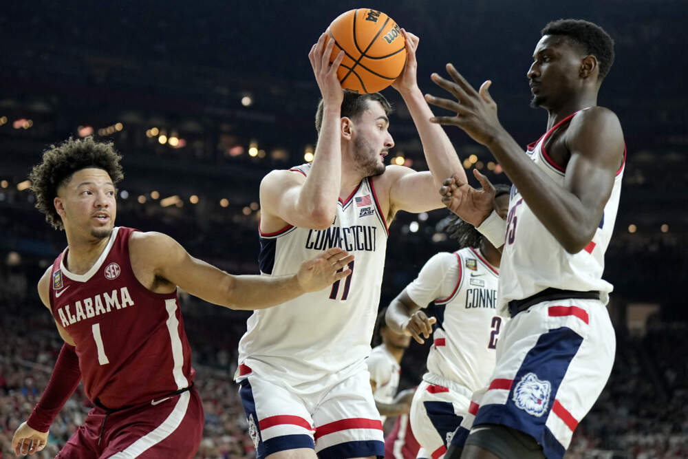 UConn forward Alex Karaban (11) pulls down a rebound as Alabama guard Mark Sears (1) defends during the second half of the NCAA college basketball game at the Final Four. (Brynn Anderson/AP)