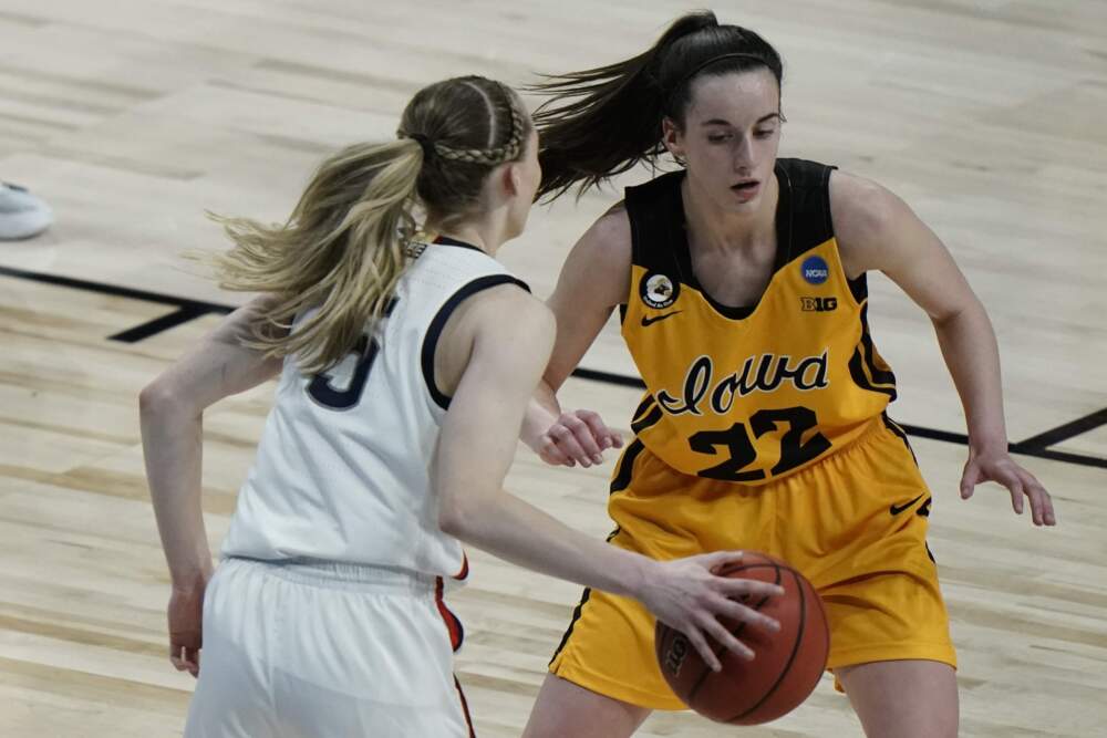Iowa's Caitlin Clark defends UConn's Paige Bueckers during the second half of an NCAA college basketball game in 2021. (Morry Gash/AP)
