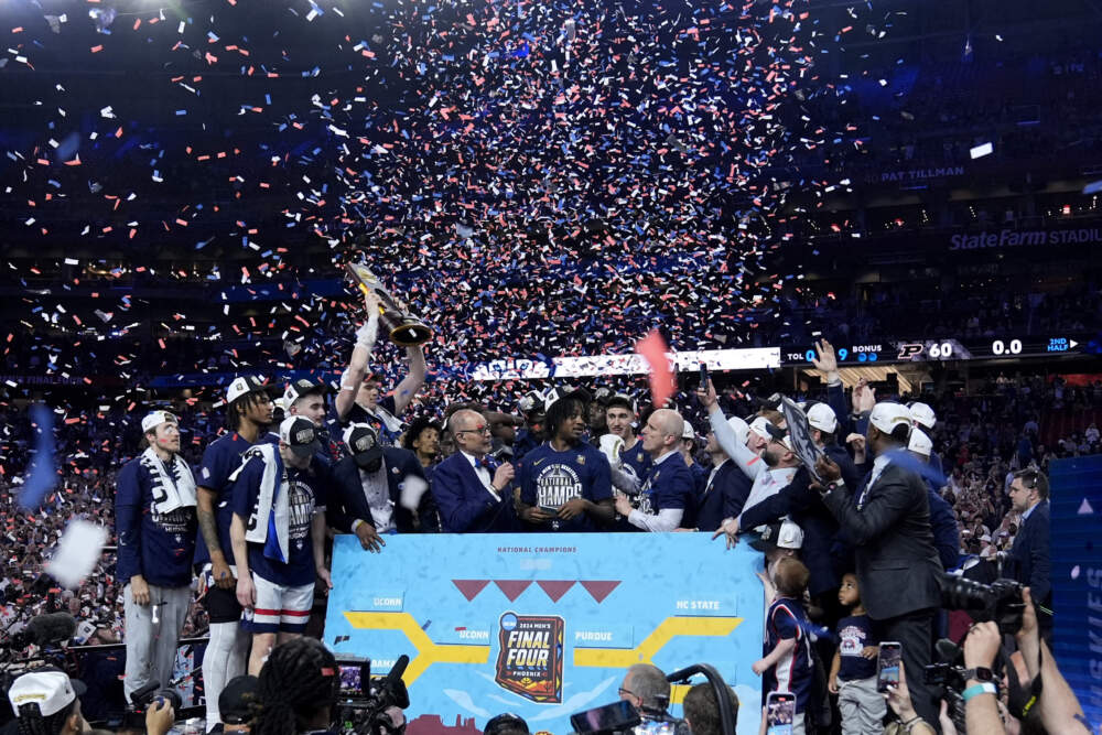 UConn players celebrate after the championship basketball game against Purdue. (Brynn Anderson/AP)