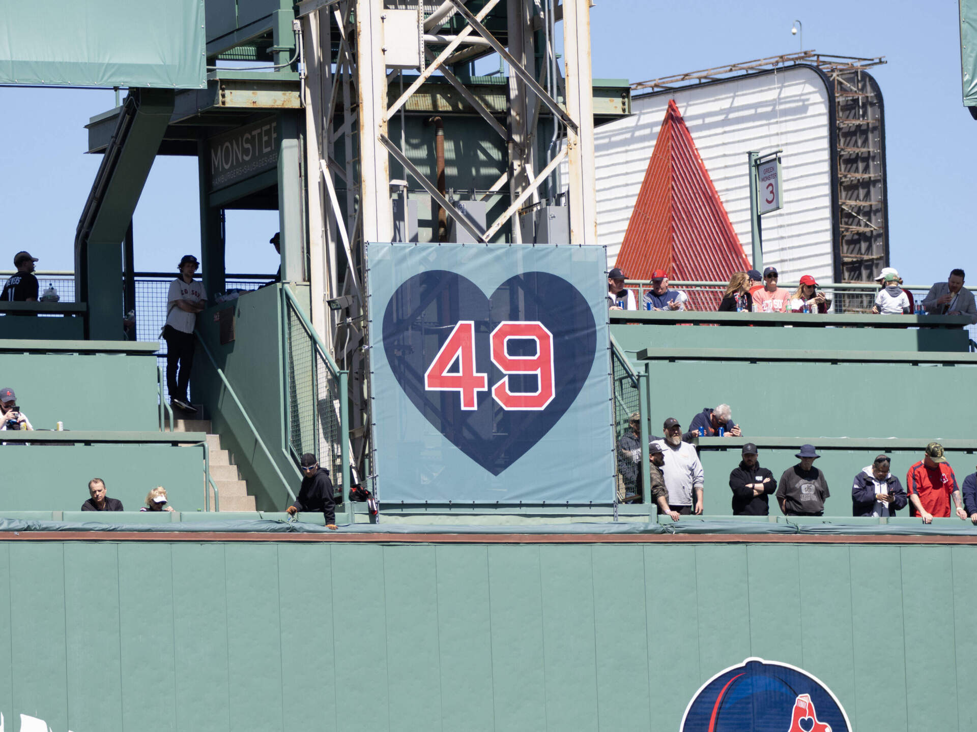 A banner over the Green Monster pays tribute to knuckleballer Tim Wakefield, who died of cancer in 2023. (Max Larkin/WBUR)
