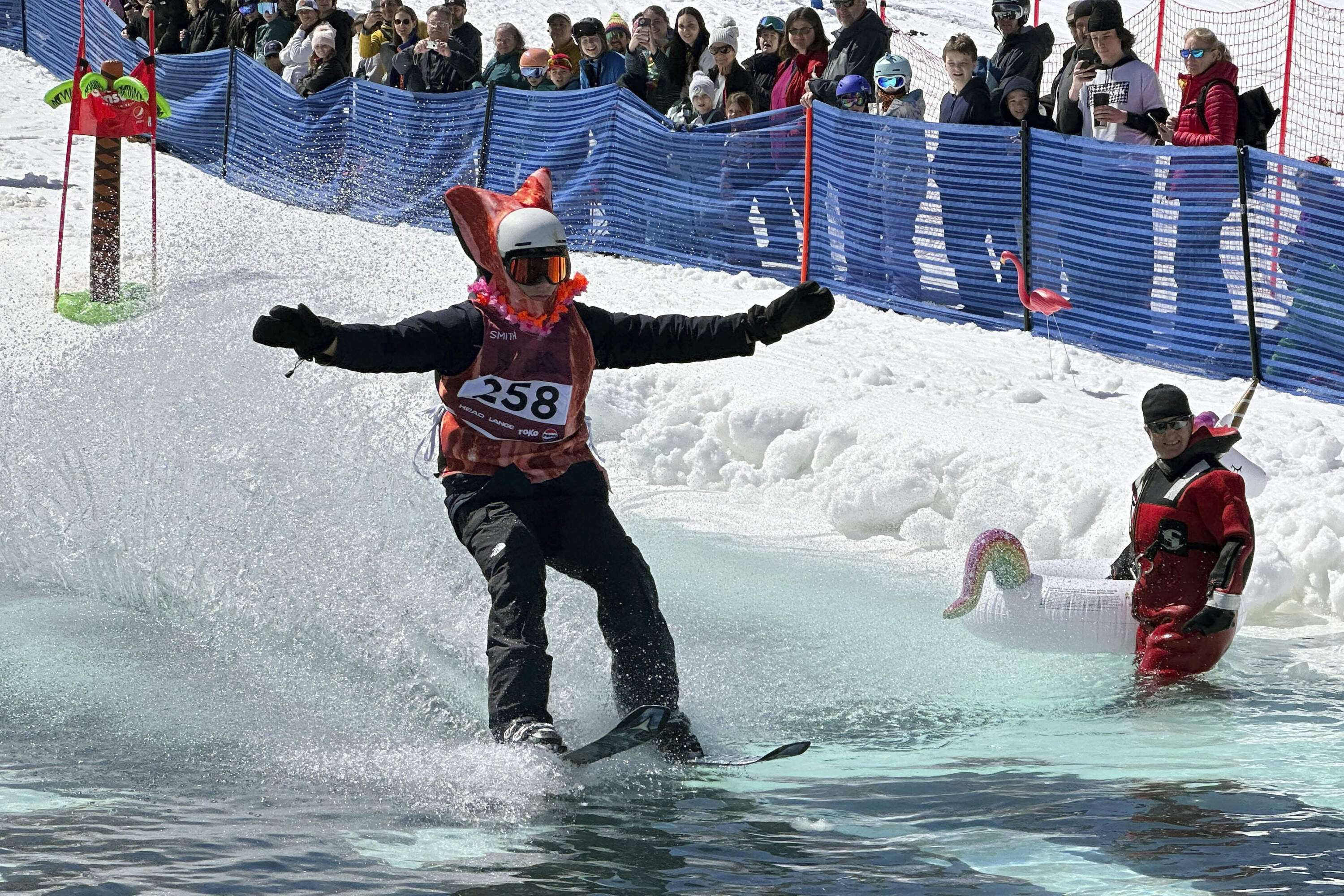 A skier participates in a pond skimming event in Gilford, N.H. (Nick Perry/AP)