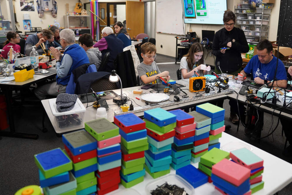 Workshop participants assemble LightSound devices at the New England Sci-Tech education center in Natick, Mass., on March 2, 2024. (Mary Conlon/AP)