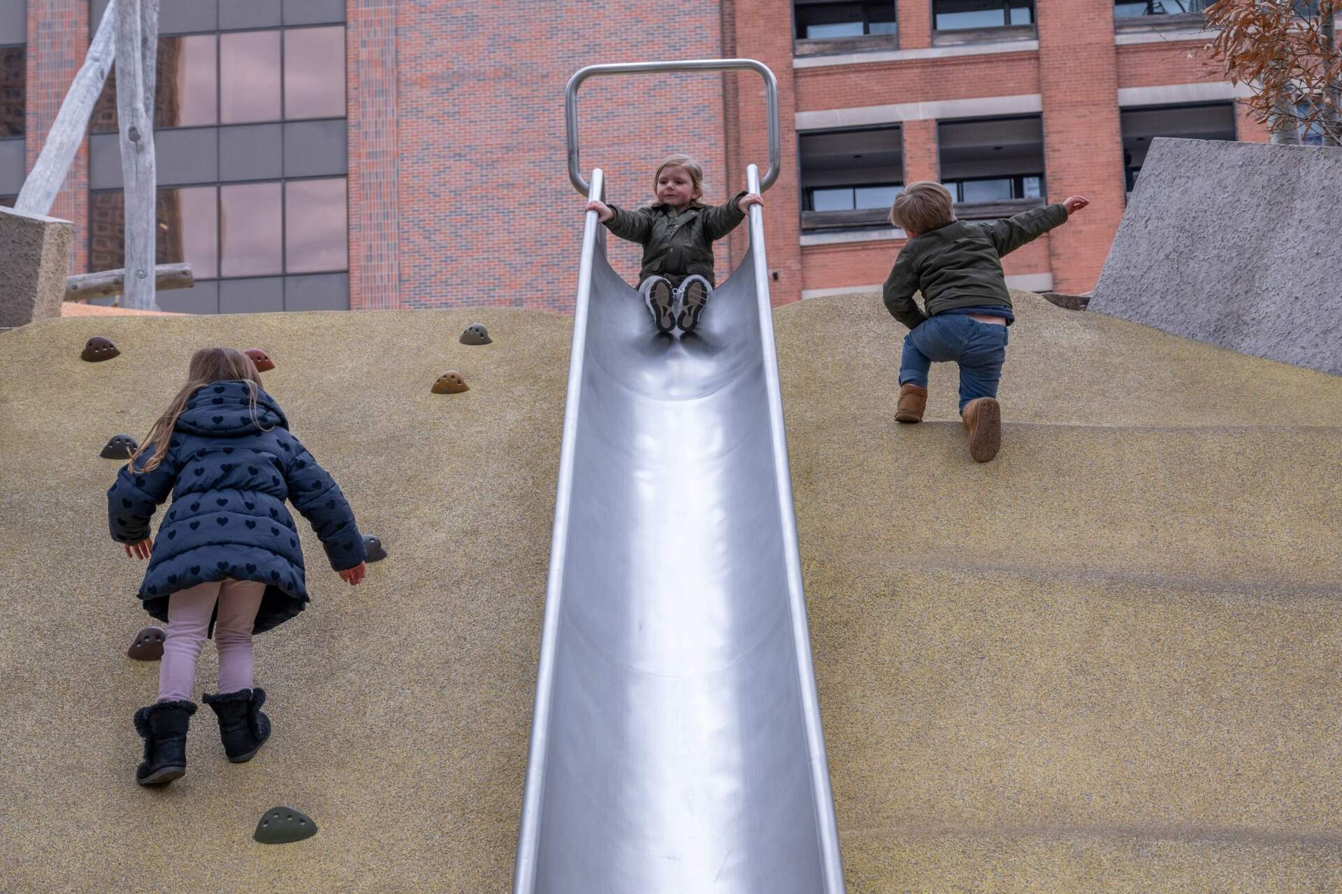 Children enjoying one of the slides in Martin's Park. (Sharon Brody/WBUR)