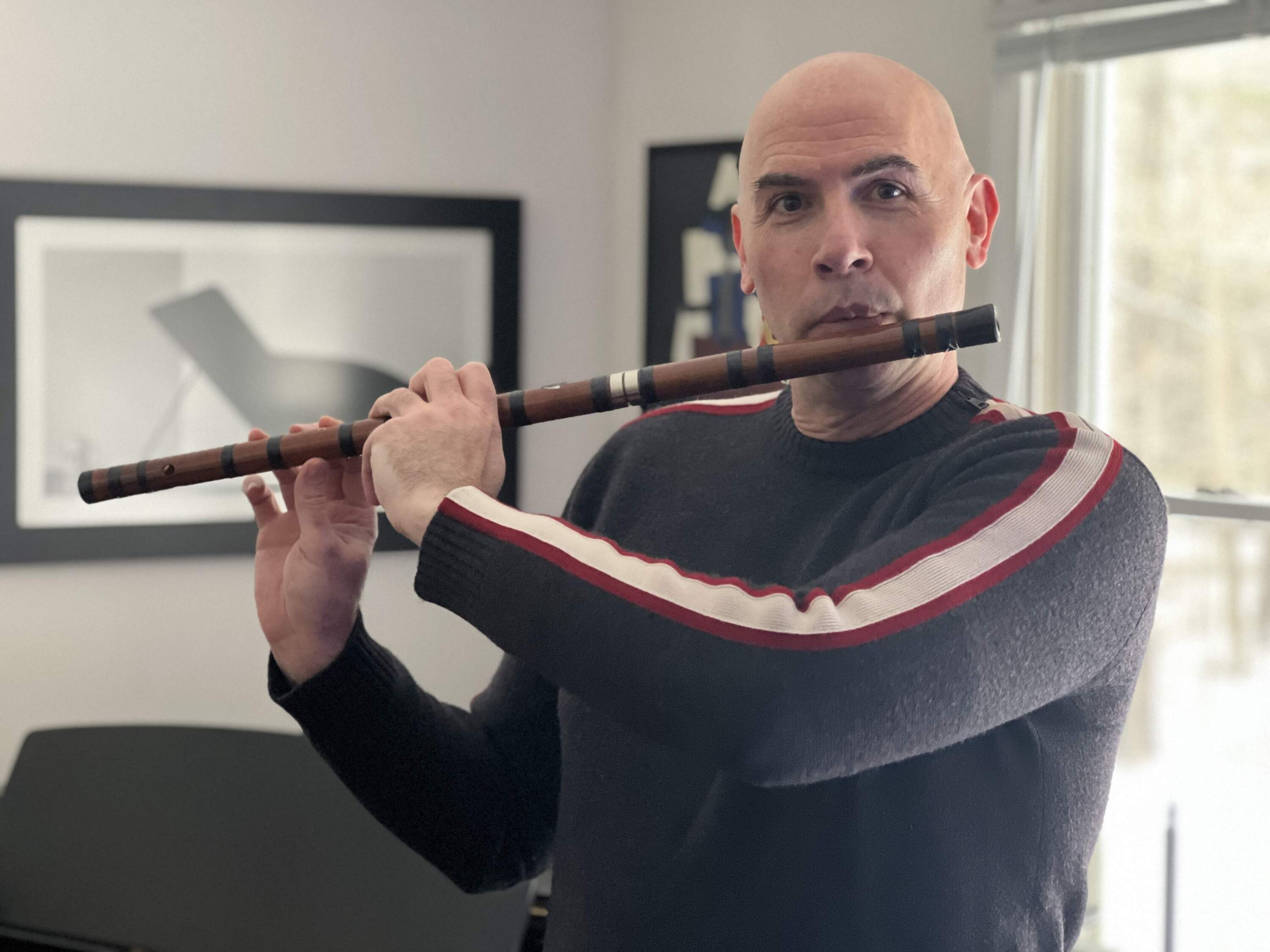 Eric Shimelonis plays the bamboo flute, one of the oldest musical instruments in Vietnam. (Courtesy of Rebecca Sheir)