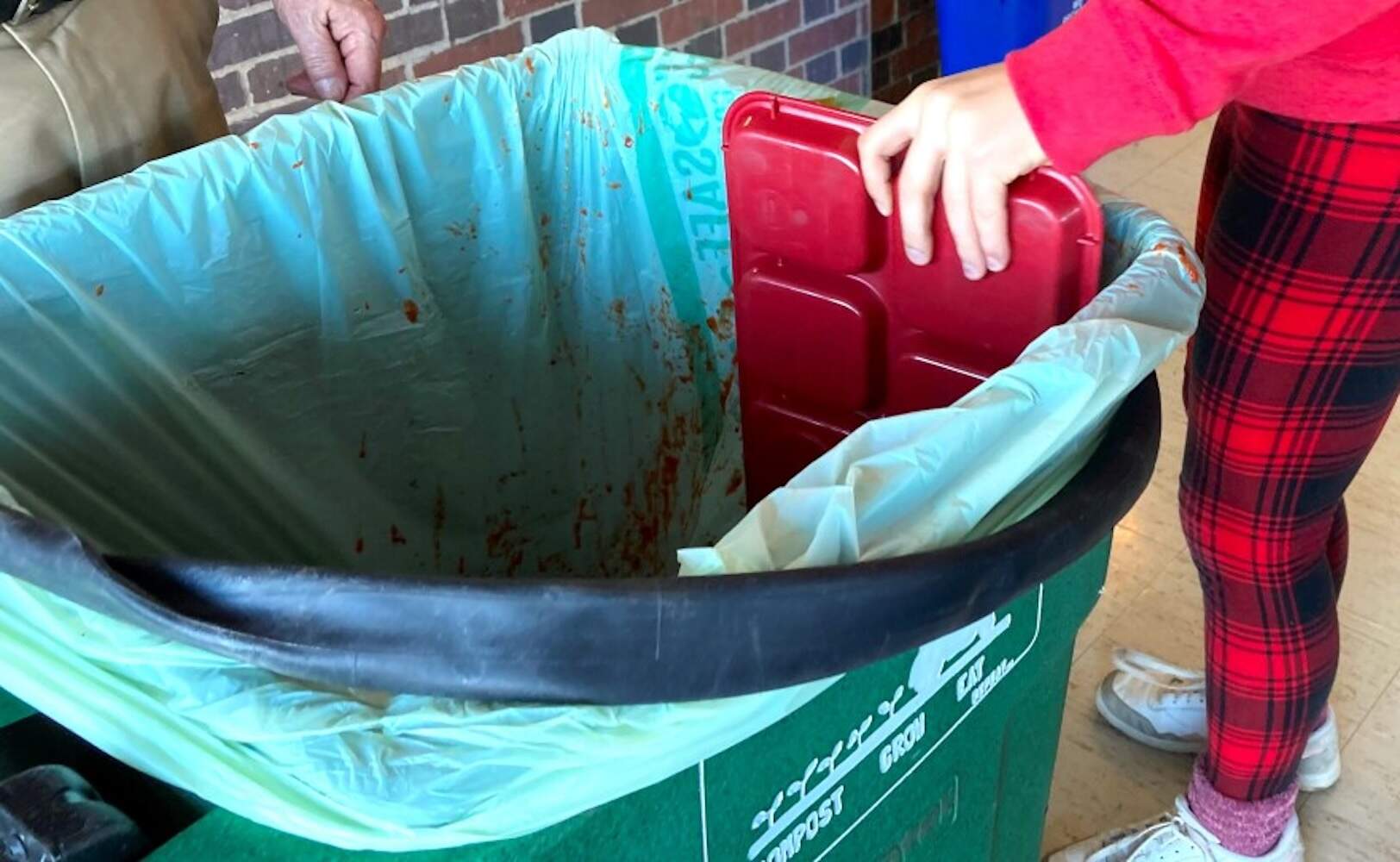 Students compost in the lunch room of Morse Pond School. (Mary B. Ryther via CAI).