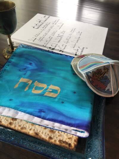 Matzo, yarmulkes and the author's Haggadah, on his dining room table. (Courtesy Daniel Osborn)