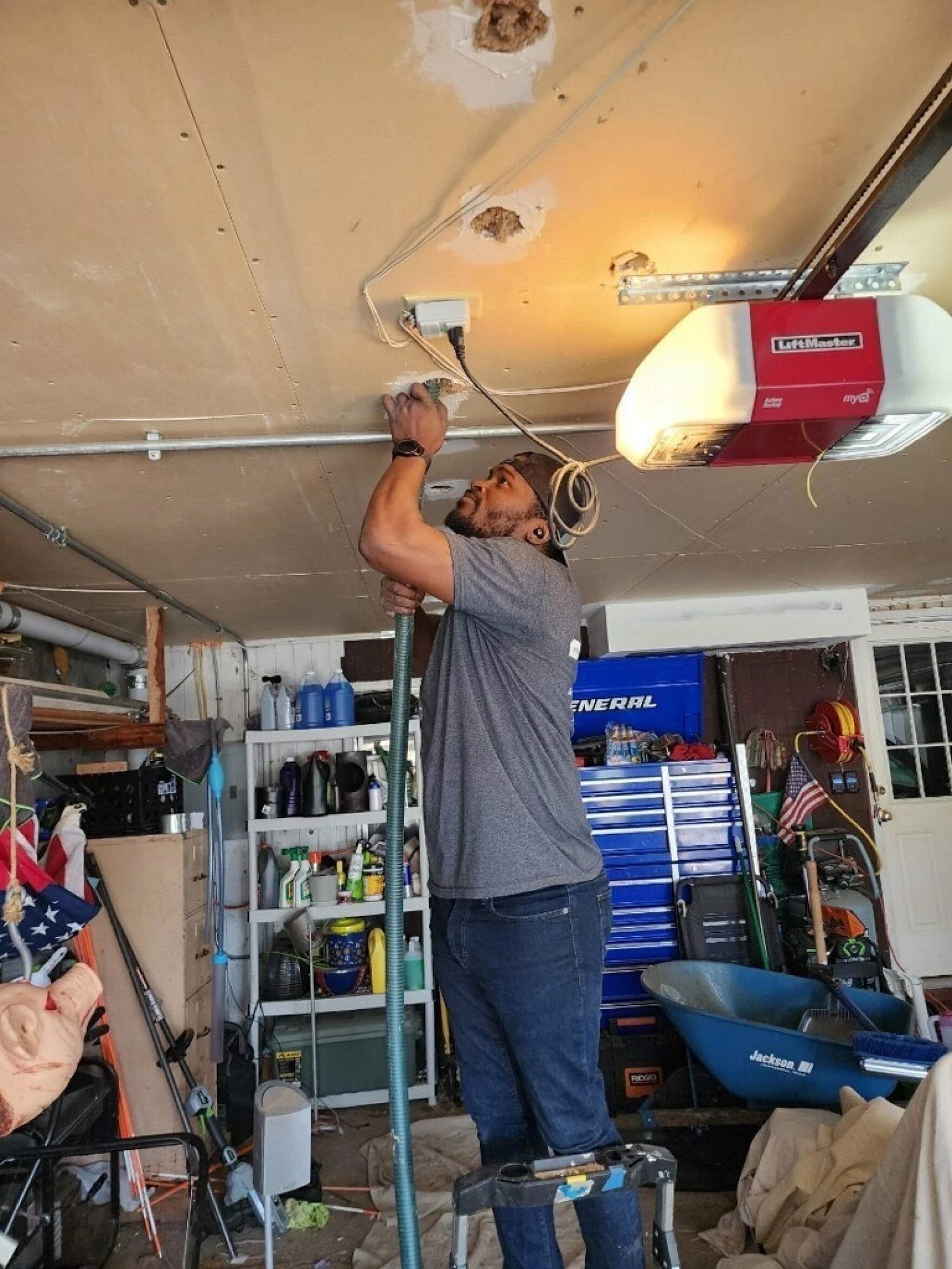 David Donovan packs insulation into the ceiling of a garage. (Courtesy of David Donovan)