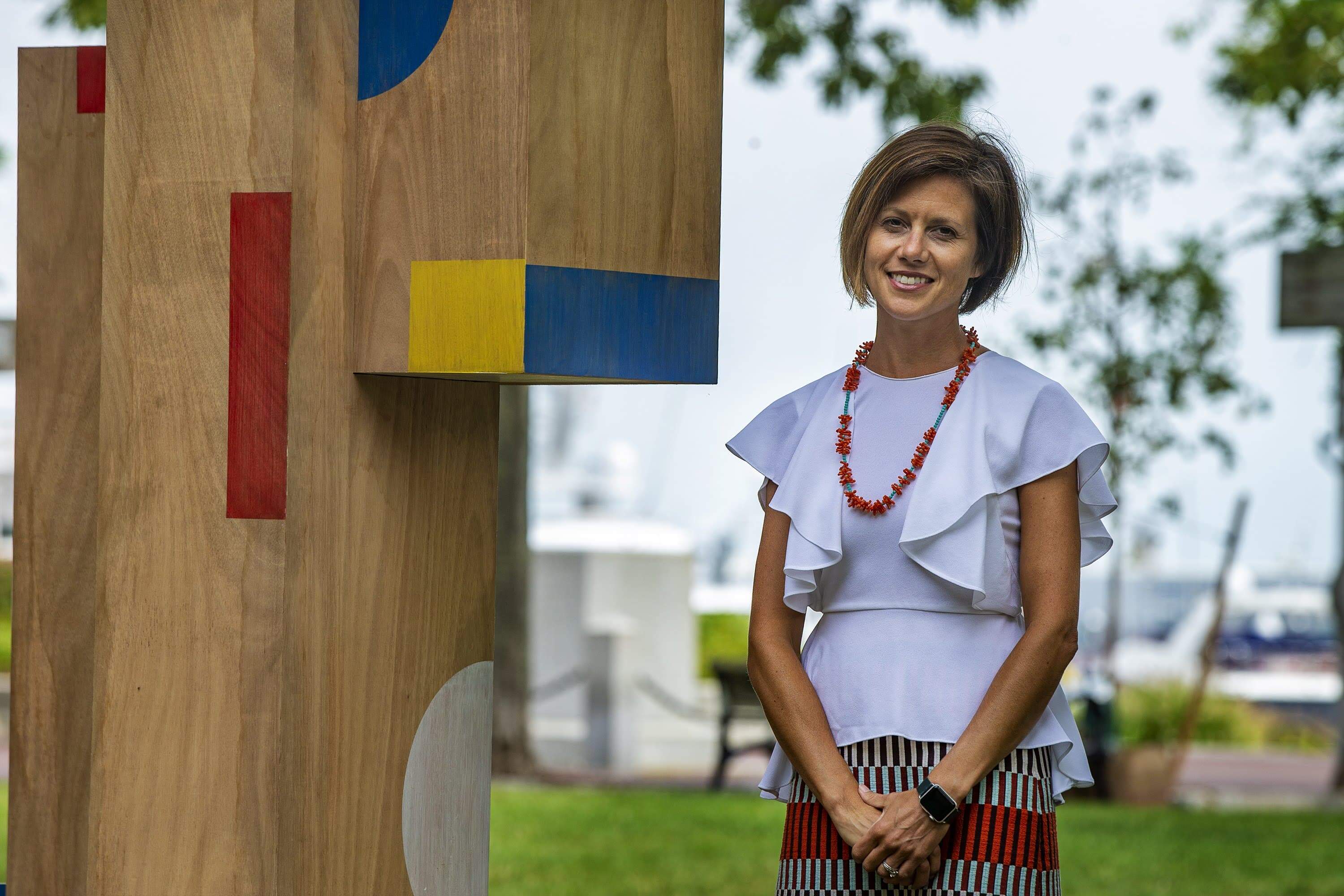 Kate Gilbert stands beside Now + There's The Shape of Play art installation in the North End in 2020. (Jesse Costa/WBUR)