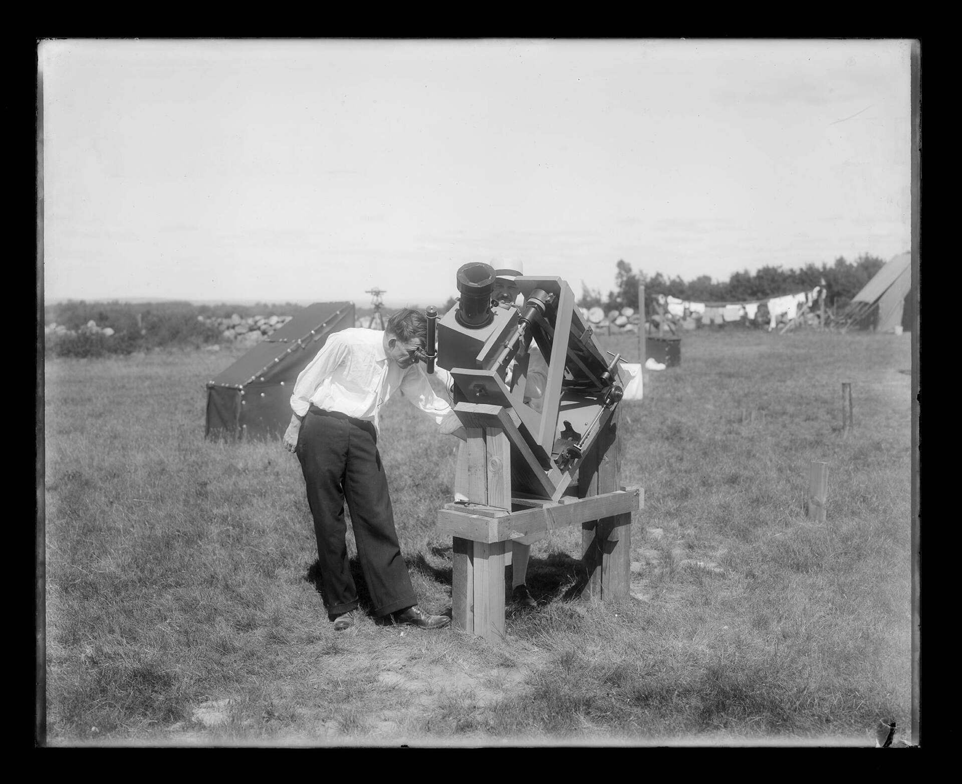 The Naval Observatory sent a party, under Commander C. H. J. Keppler, U.S.N., to observe the total solar eclipse in Maine in 1932. The team made photographs of the corona with cameras of sizes ranging from a 65-foot focal length to a motion-picture camera of 17 inches focal length. (United States Naval Observatory) 