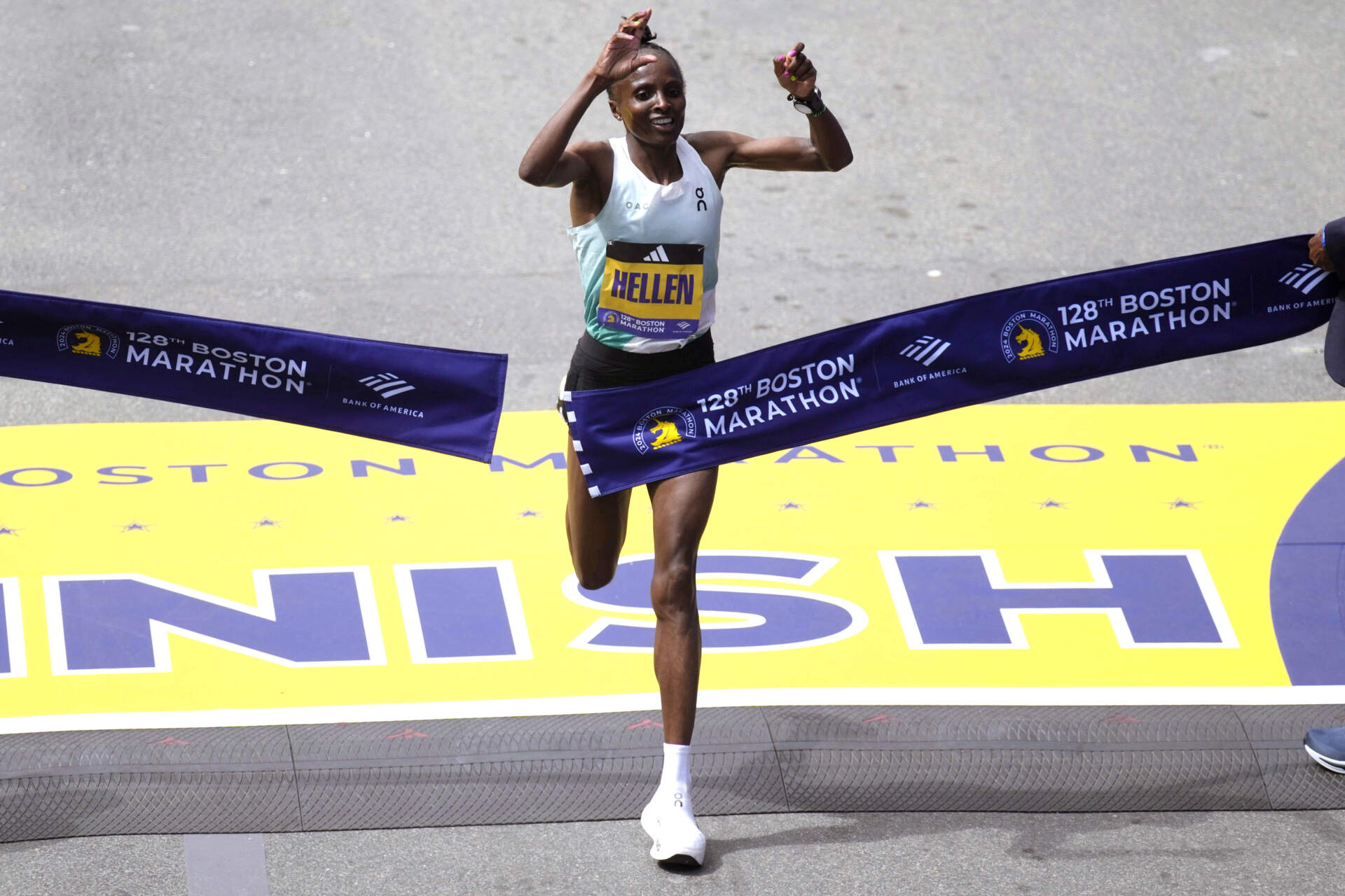 Hellen Obiri, of Kenya, raises her arms as she wins the women's division at the Boston Marathon. (Charles Krupa/AP)
