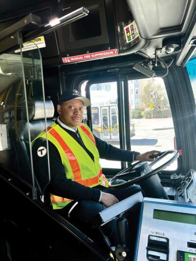 Obed Ferdinand of Mattapan is now driving buses on various MBTA routes in the system. “Going through the [training] program ended up giving me more confidence,” he says. (Cassidy McNeeley/Dorchester Reporter)