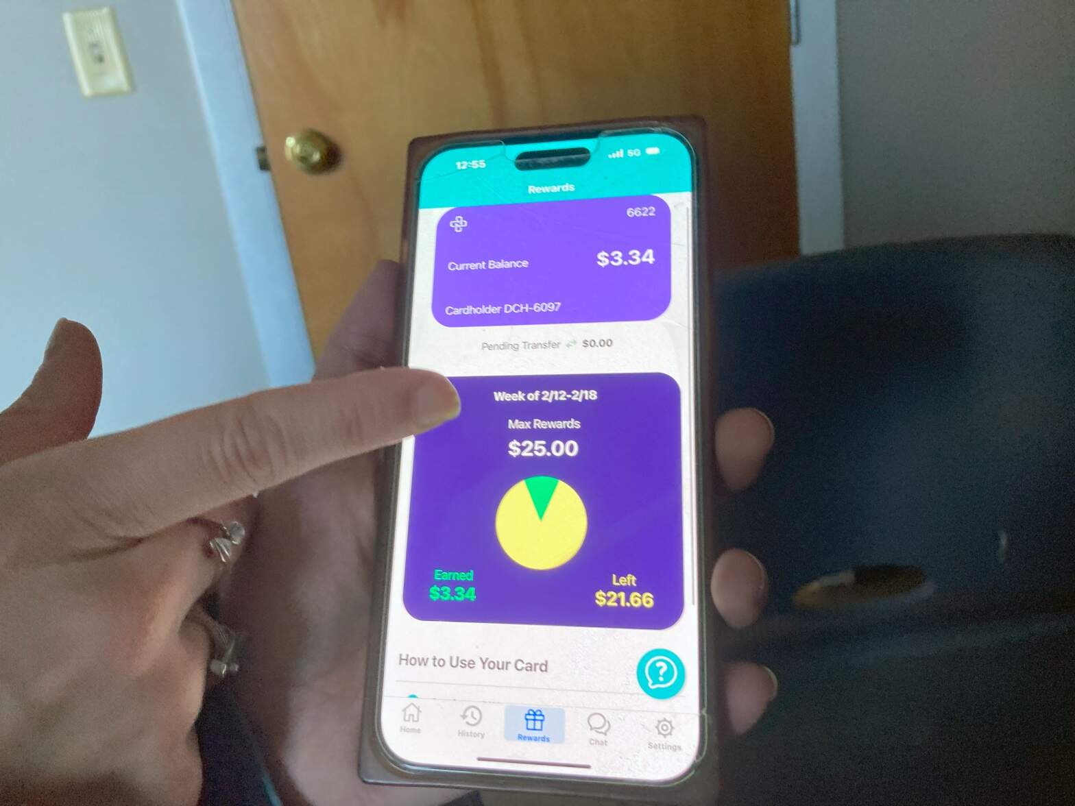 Samantha, 30, of Providence, R.I. shows the cash rewards that she’s earned on a smartphone app designed to help her stay off drugs. (Lynn Arditi / The Public's Radio)