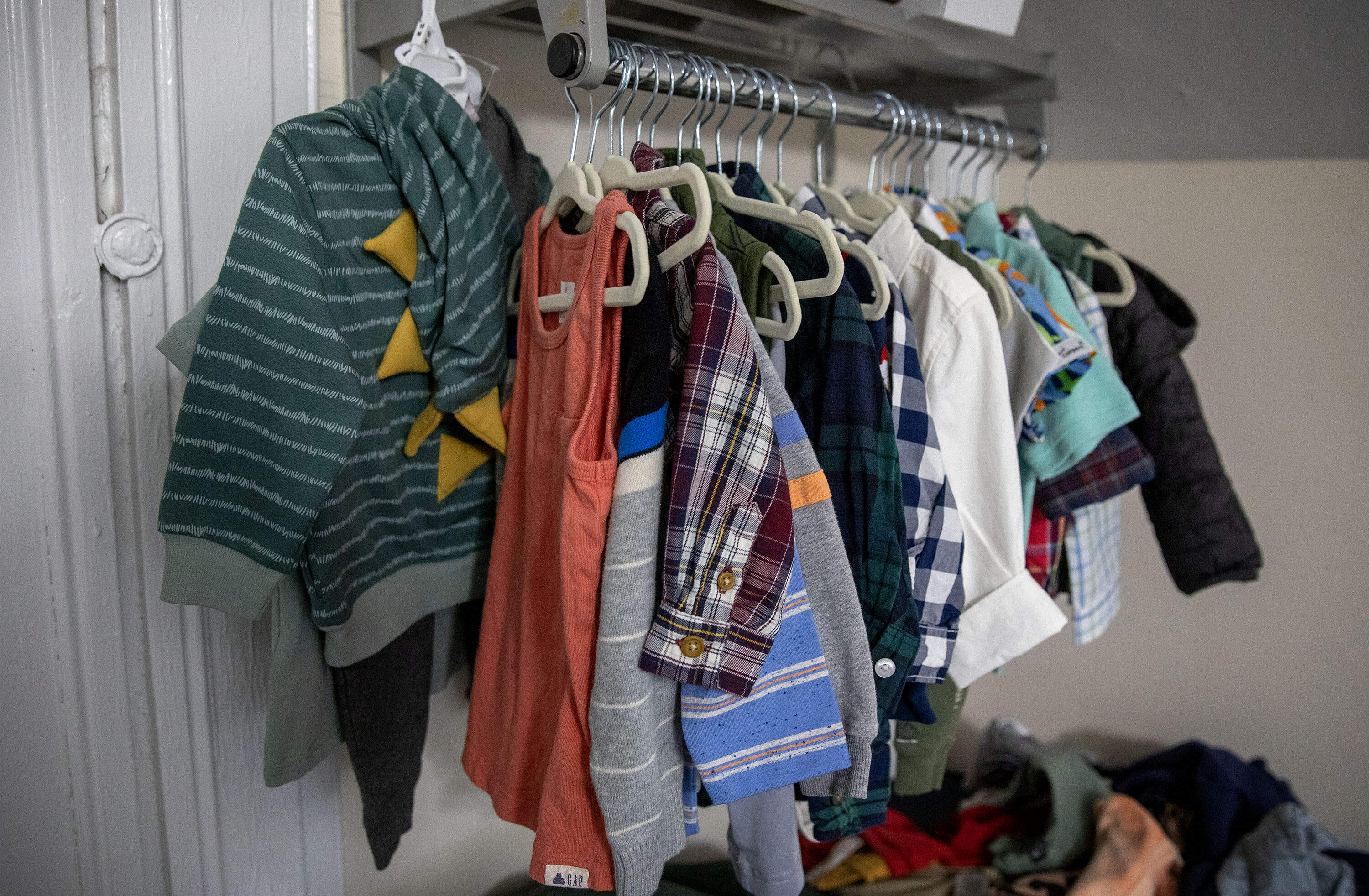 Leudi's clothes hang in the shelter room he shares with his mother (Robin Lubbock/WBUR)