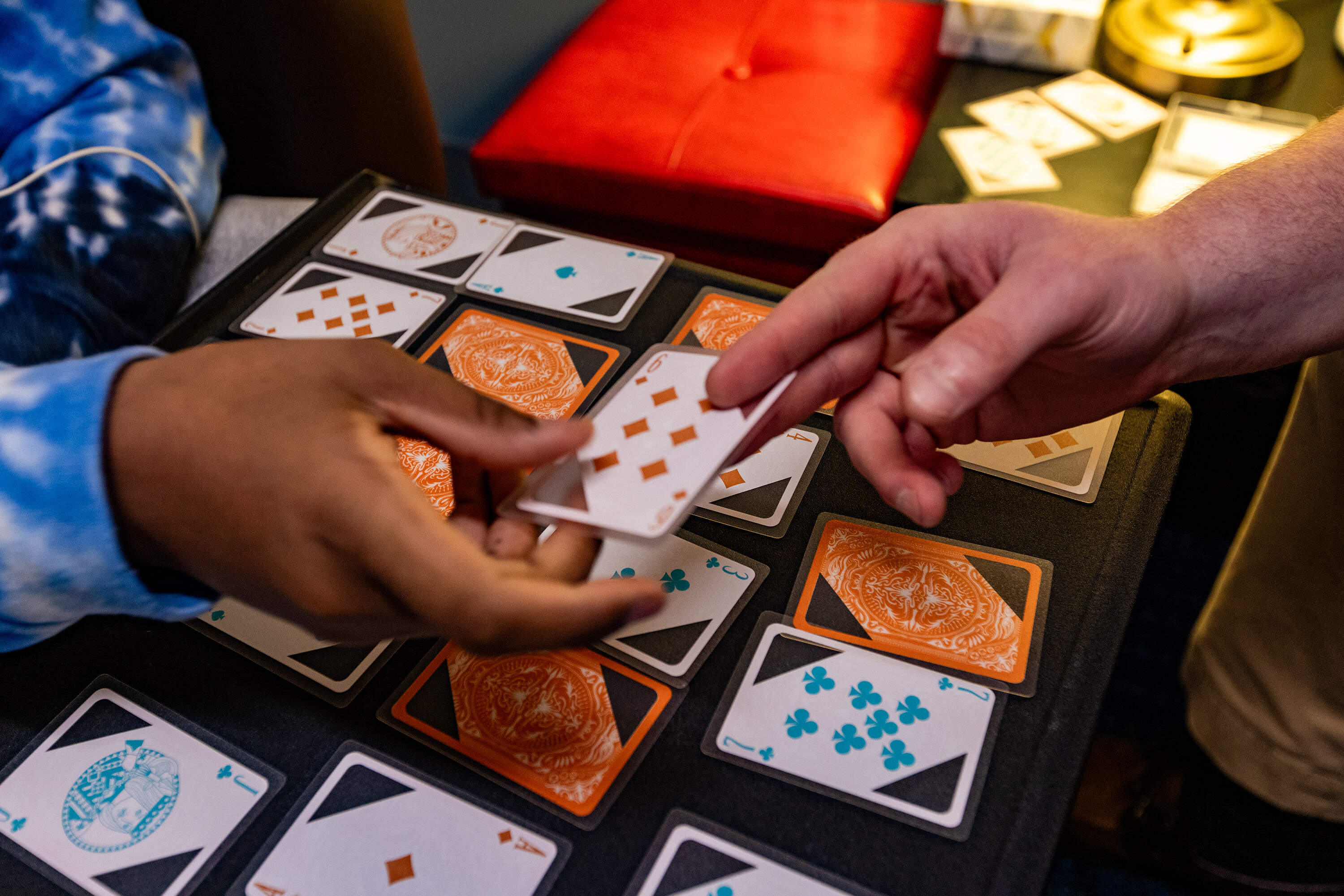 Young Adult Peer Mentor Jake Look and 16-year-old Nathanial pass cards while they play a game of Trash during a session at Riverside Community Care in Milford, Mass. (Jesse Costa/WBUR)