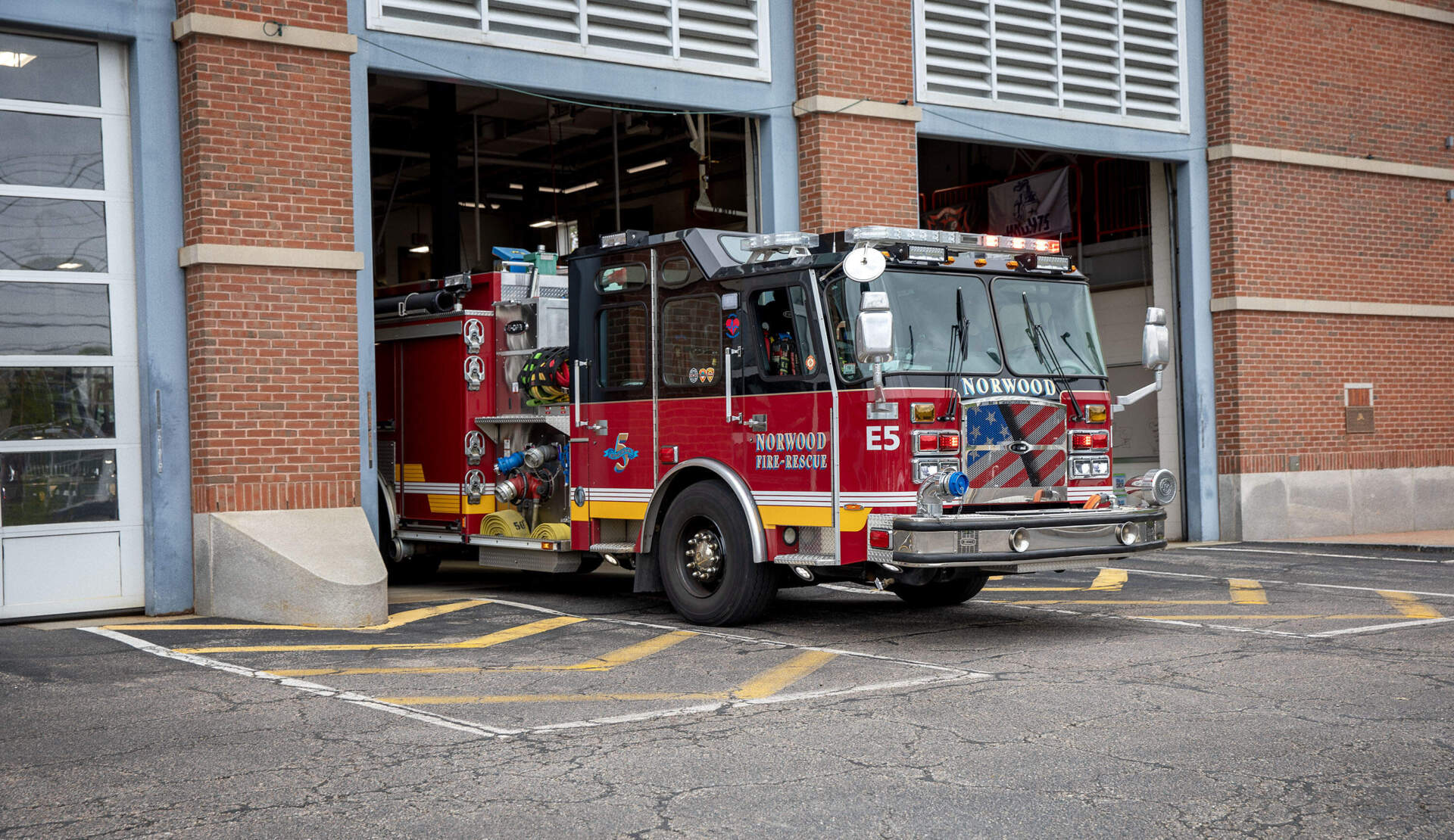 A fire truck backs into the garage doors of Norwood fire station. (Robin Lubbock/WBUR)