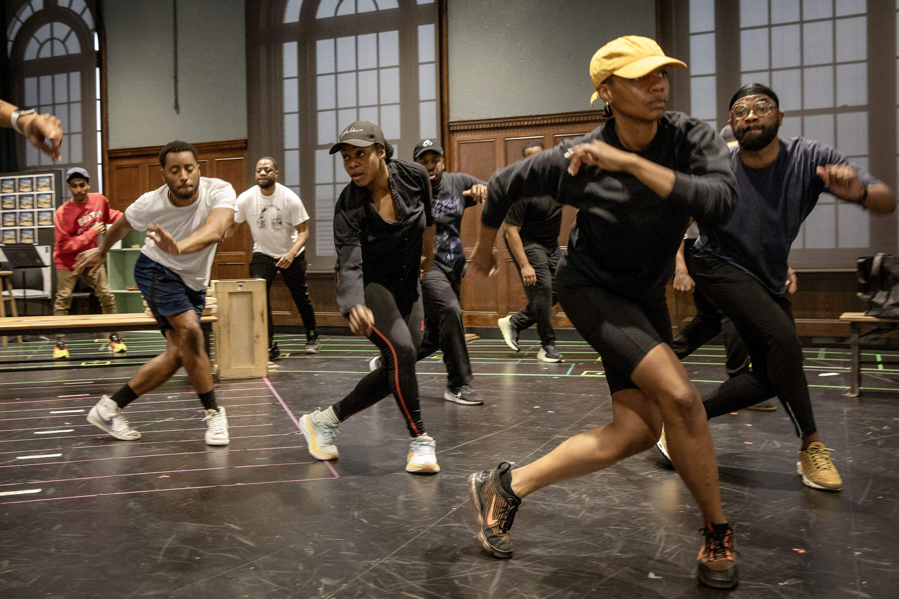 Actor Jennifer Mogbock (center) runs through dance moves at a rehearsal of with the cast of &quot;Toni Stone&quot; at The Huntington Theatre. (Robin Lubbock/WBUR)