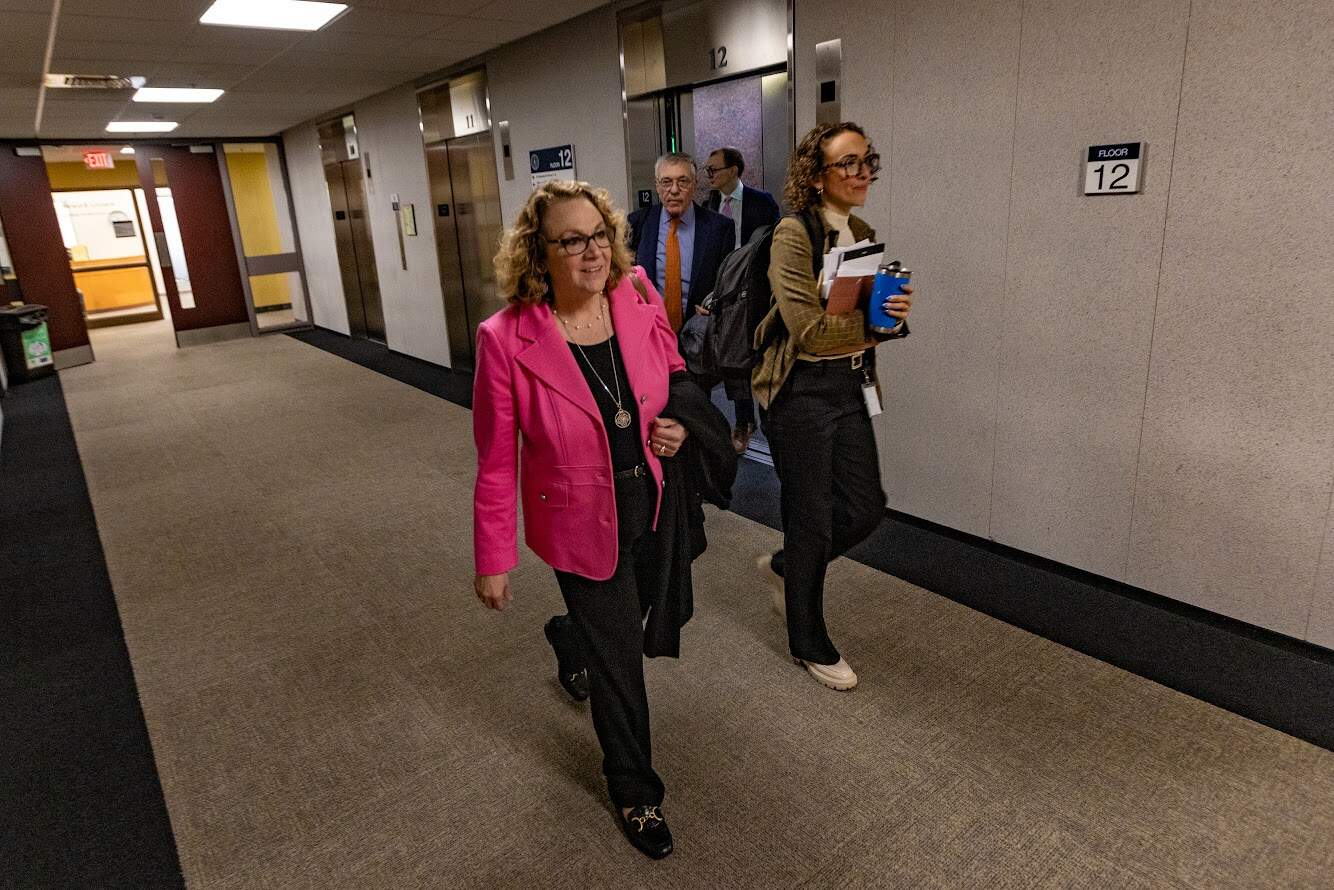 Suspended Cannabis Control Commission Chair Shannon O'Brien heads towards the hearing room to meet with Treasurer Deborah Goldberg. (Jesse Costa/WBUR)