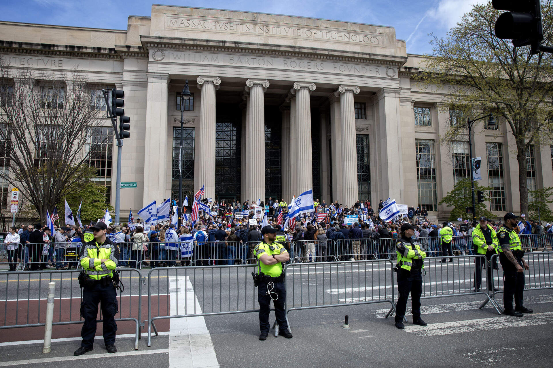 Demonstrators wave Israeli flags on the steps of MIT at rally arranged by the New England chapter of the Israeli American Council. (Robin Lubbock/WBUR)