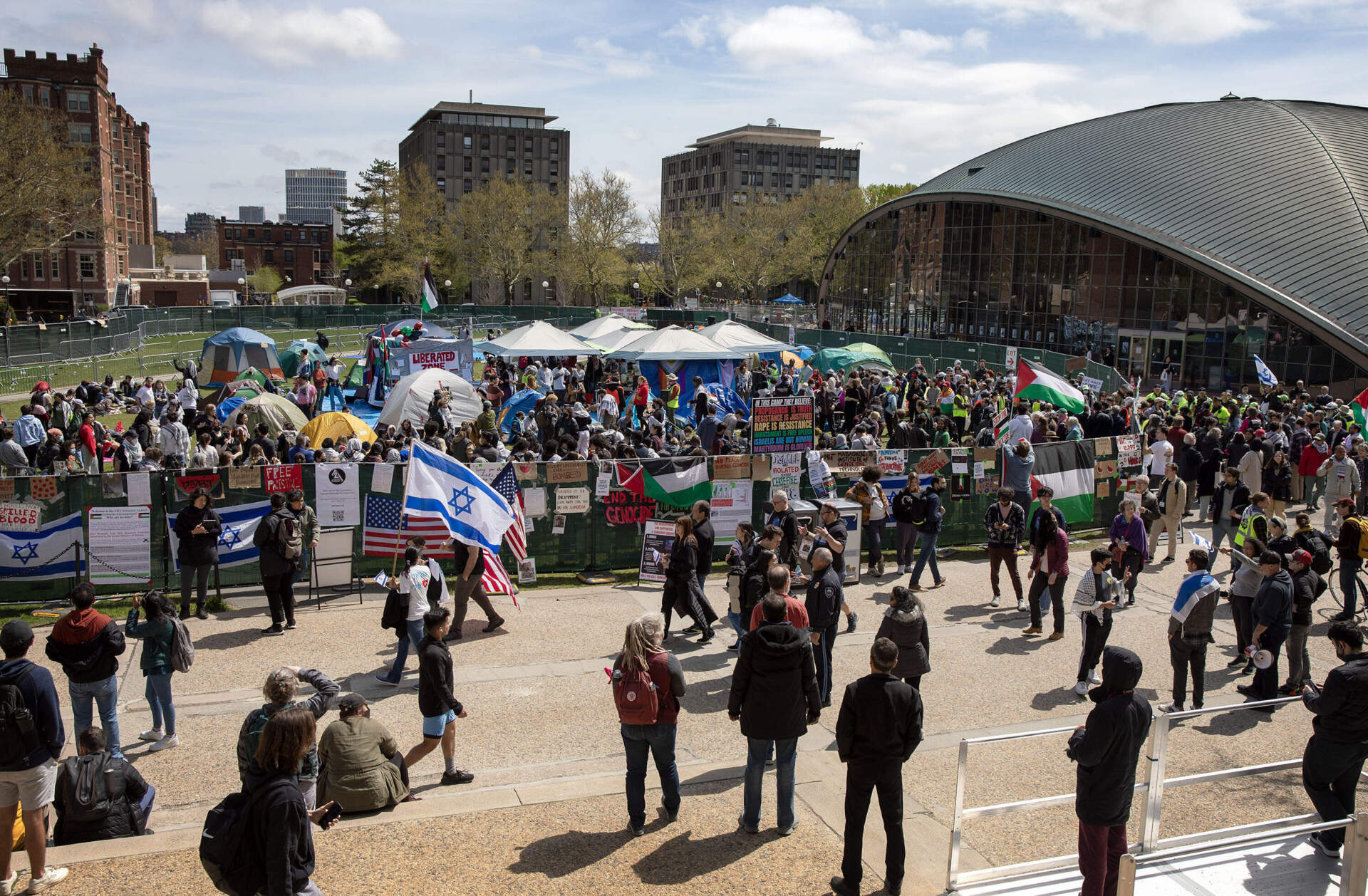 People gathered for a rally at the encampment protesting the war in Gaza on MIT's Kresge Lawn. (Robin Lubbock/WBUR)