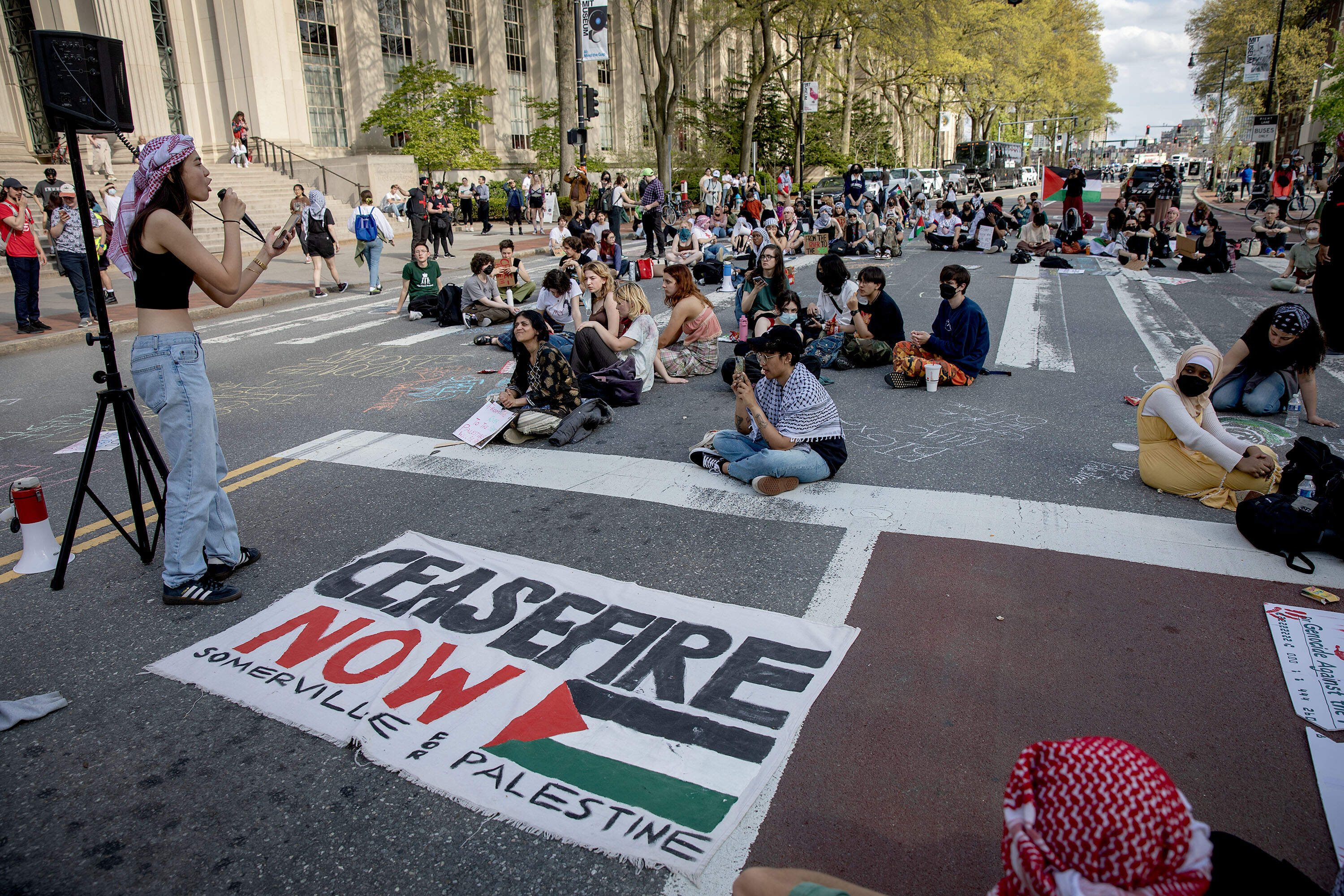 Student protesters block Massachusetts Avenue in support of the pro-Palestinian encampment on the Kresge Oval. (Robin Lubbock/WBUR)