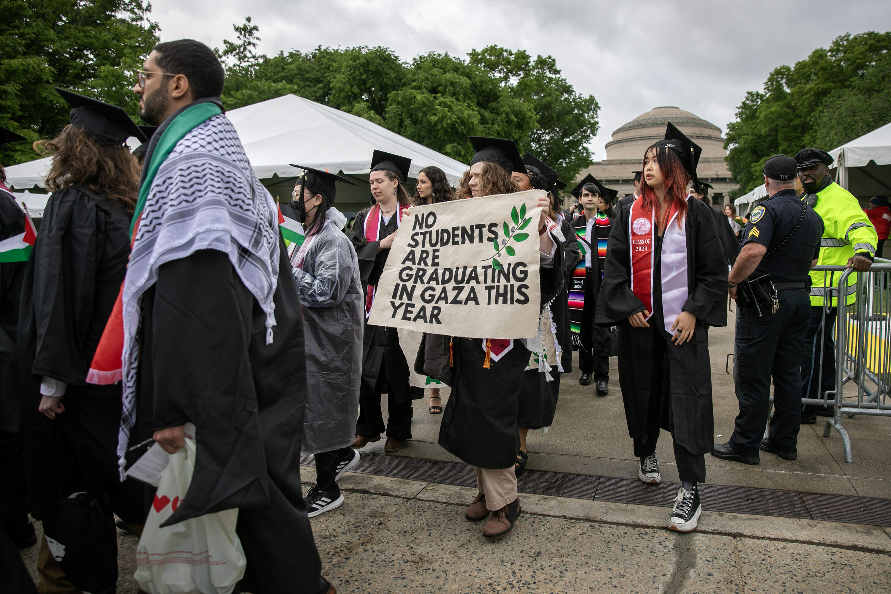 Protesting graduates walk out of MIT's commencement ceremony. (Robin Lubbock/WBUR)