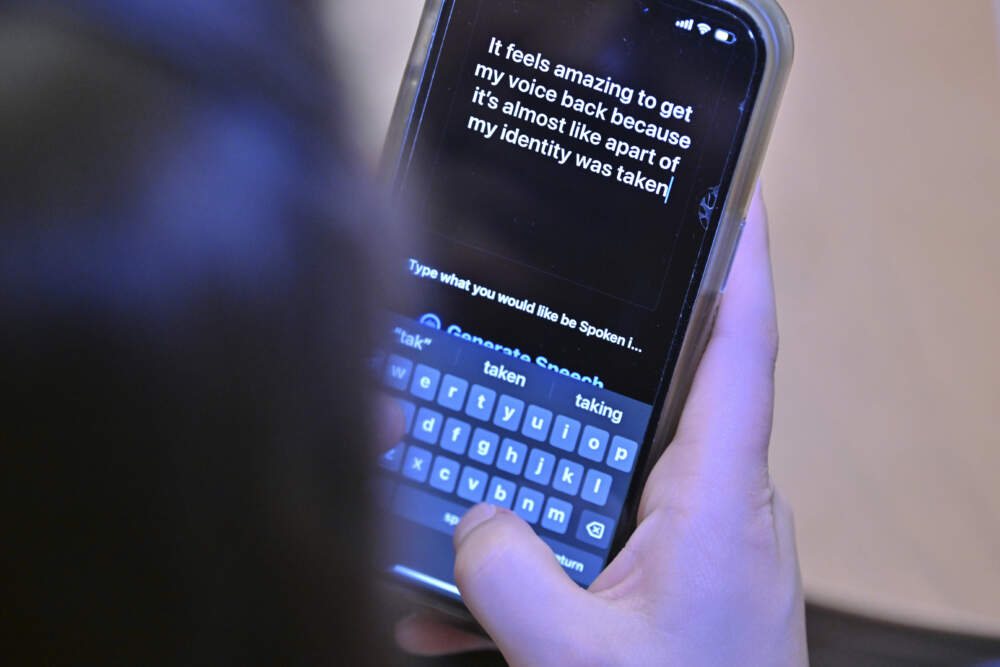 Alexis Bogan types a response to a reporter's question with an app which approximates her lost voice, Thursday, March 11, 2024, at Rhode Island Hospital in Providence, R.I. (Josh Reynolds/AP)