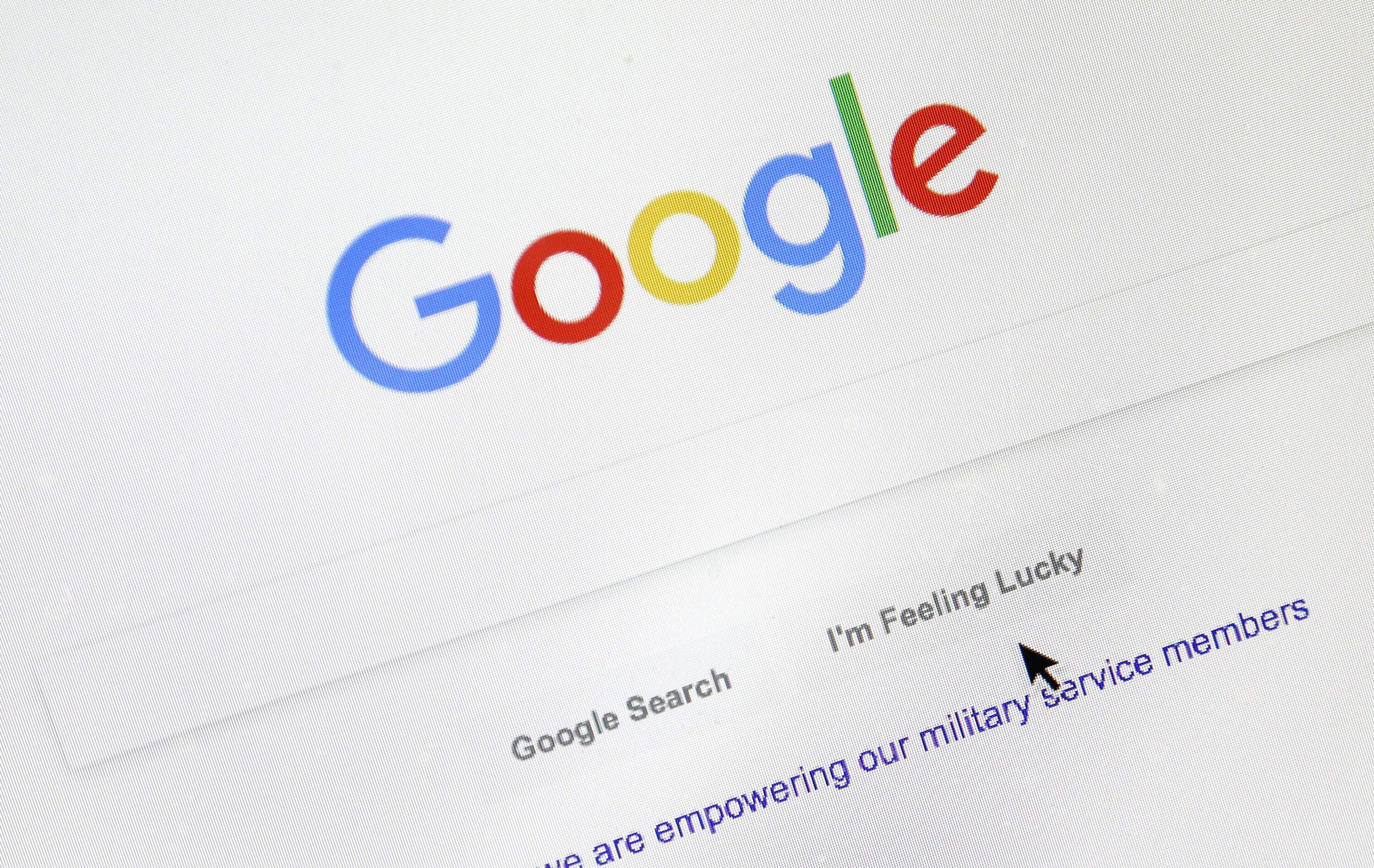 A cursor moves over Google's search engine page. (Don Ryan/AP)