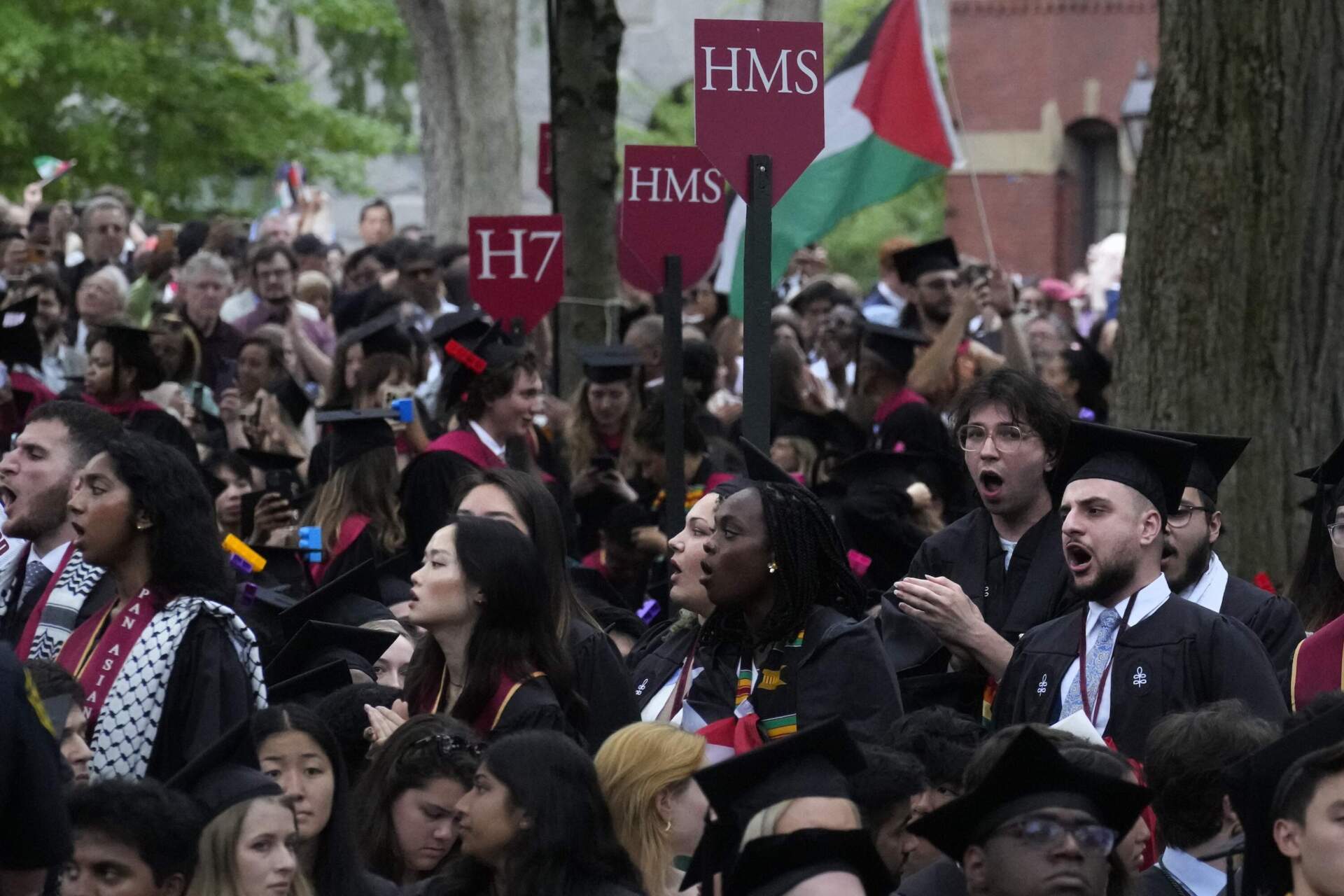 Graduating students chant as they depart commencement in protest to the 13 graduating seniors who were not allowed to participate due to protest activities at Harvard University, Thursday, May 23, 2024. (Charles Krupa/AP)