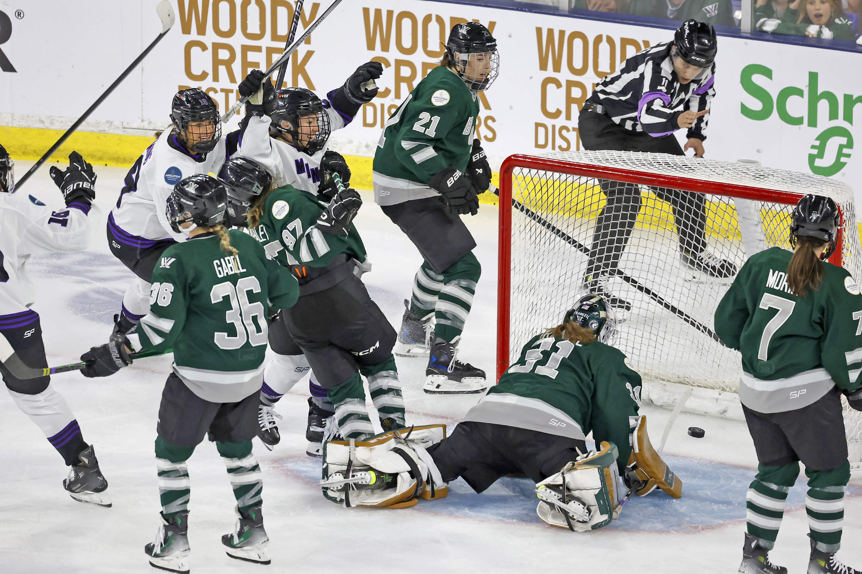 Minnesota forward Liz Schepers, center, raises her arms in celebration after scoring as Boston goalie Aerie Frankel looks at the puck in the net during the second period of Game 5 of the PWHL Walter Cup hockey finals, Wednesday May 29, 2024, in Lowell, Mass. (Mary Schwalm/AP)