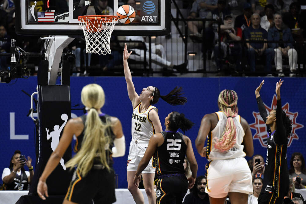 Indiana Fever guard Caitlin Clark (22) scores her first basket against the Connecticut Sun during the second quarter of a WNBA basketball game, Tuesday, May 14, 2024, in Uncasville, Conn. (Jessica Hill/AP)