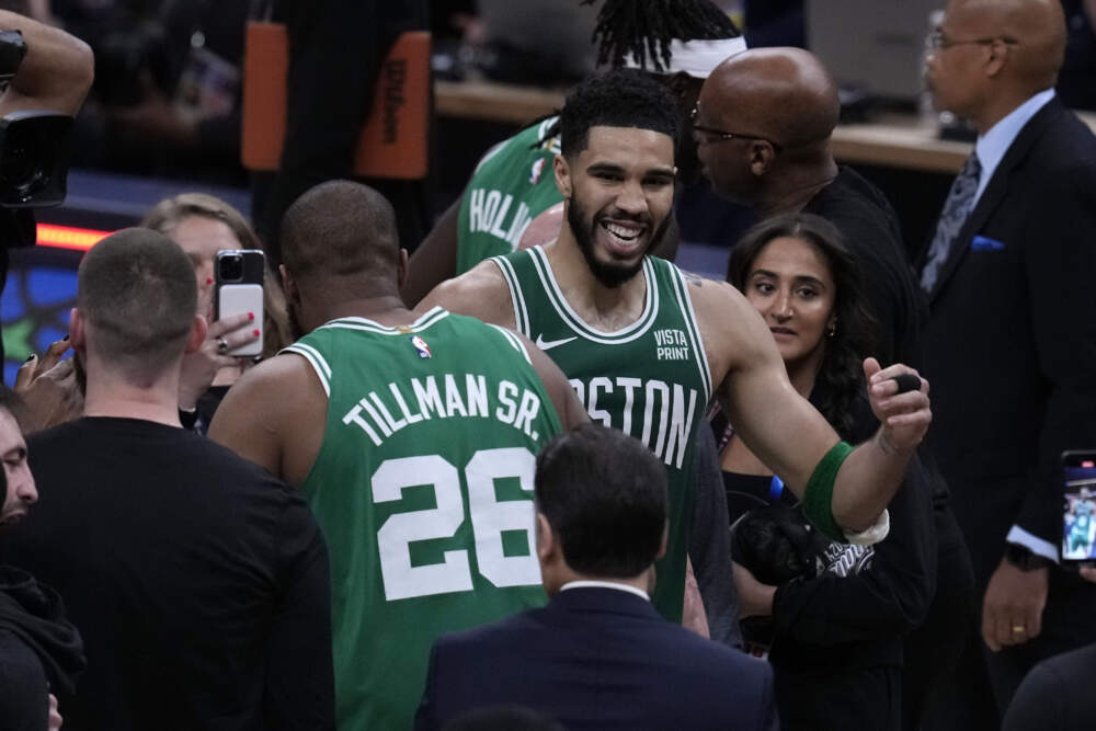 Boston Celtics forward Jayson Tatum celebrates with teammate forward Xavier Tillman (26) after Game 4. (Darron Cummings/AP)