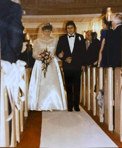 The author's mother, Elizabeth Wynn Shirk, walks down the aisle with her brother, James Wynn, at her wedding in 1986. (Courtesy Abbigail Shirk)