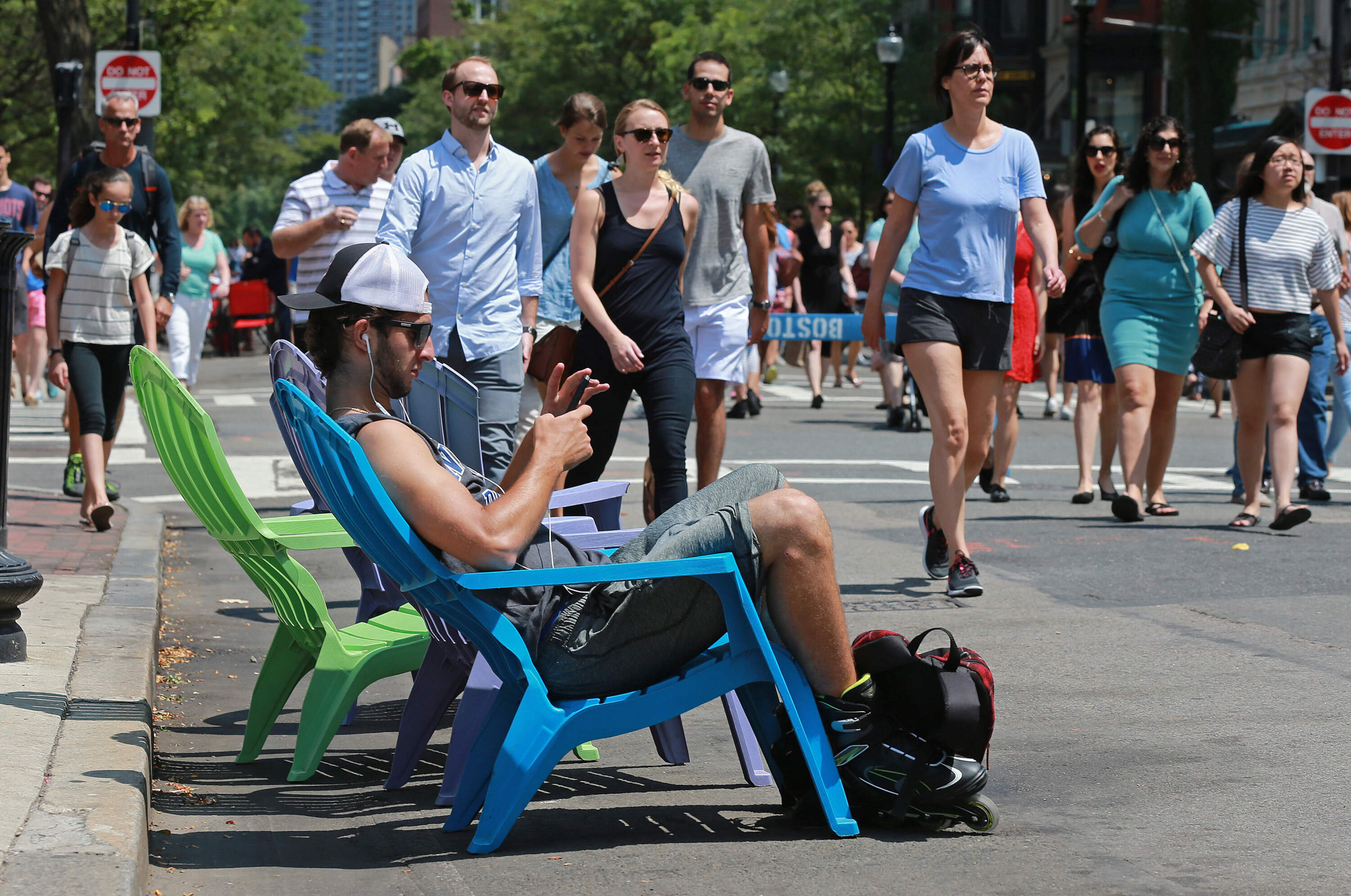 A rollerblader takes a break in a chair during Open Newbury in 2017. (Photo by Matt West/MediaNews Group/Boston Herald via Getty Images)