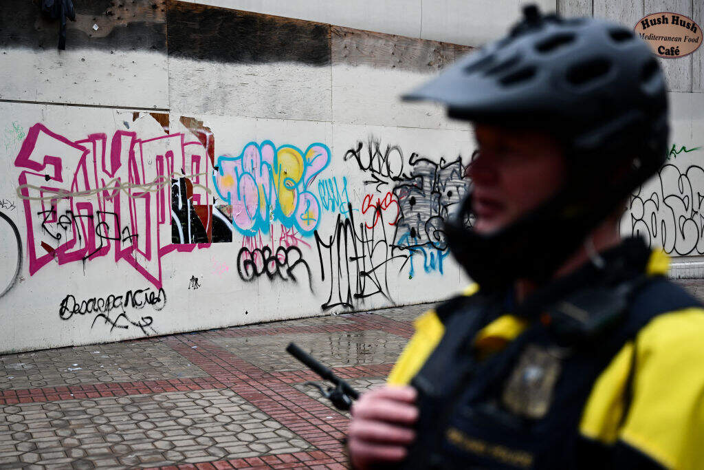 Portland Police officer Eli Arnold talks about the progress made against drug dealers during a patrol on a bicycle following the decriminalization of all drugs in downtown Portland, Oregon on January 25, 2024. (PATRICK T. FALLON/AFP via Getty Images)